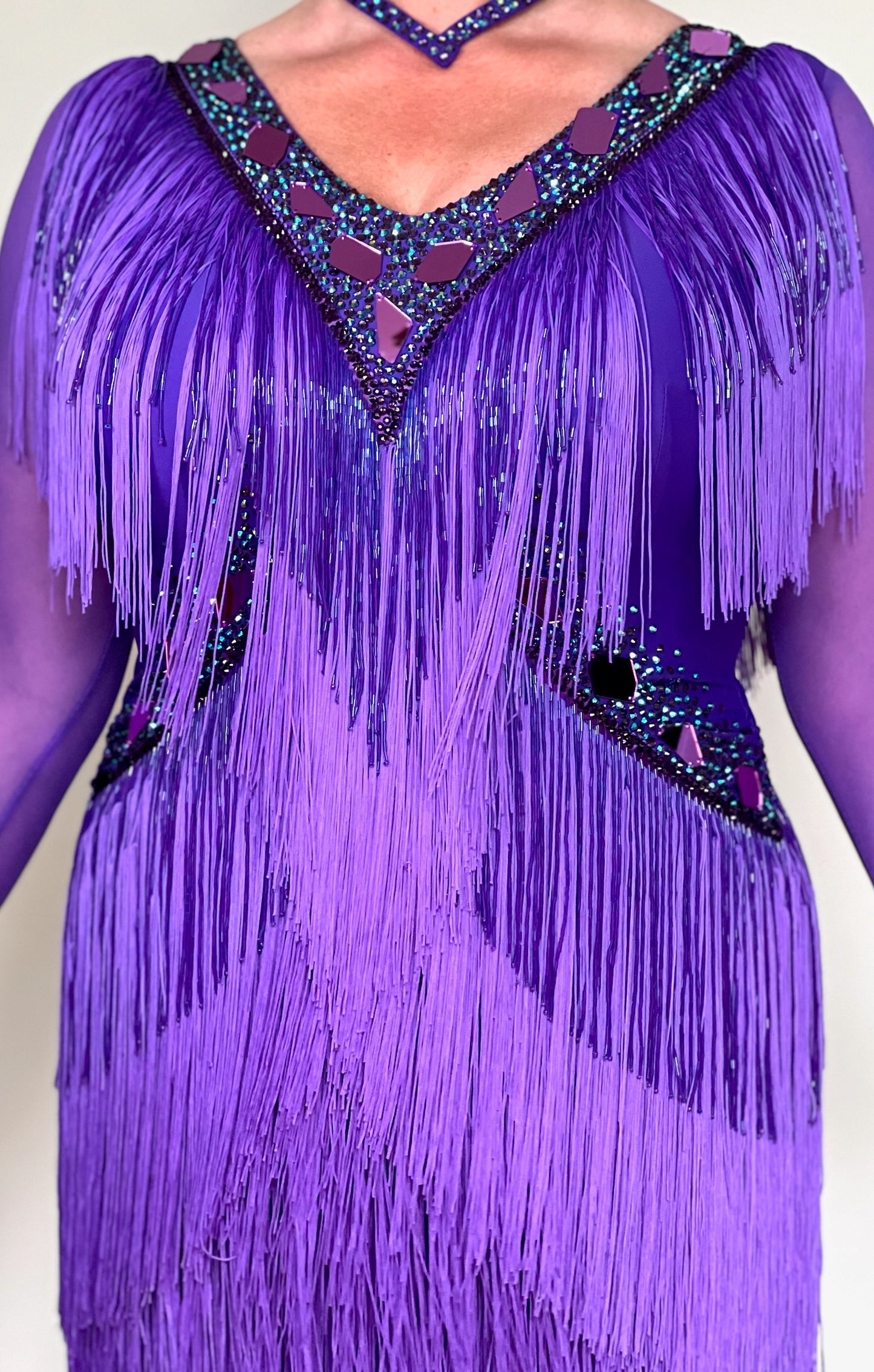 181 Purple Latin Dance Dress. Very full layered fringe. Decorated with purple mirrors, purple bead droppers and purple ab stones. High back to give option for wearing own bra.