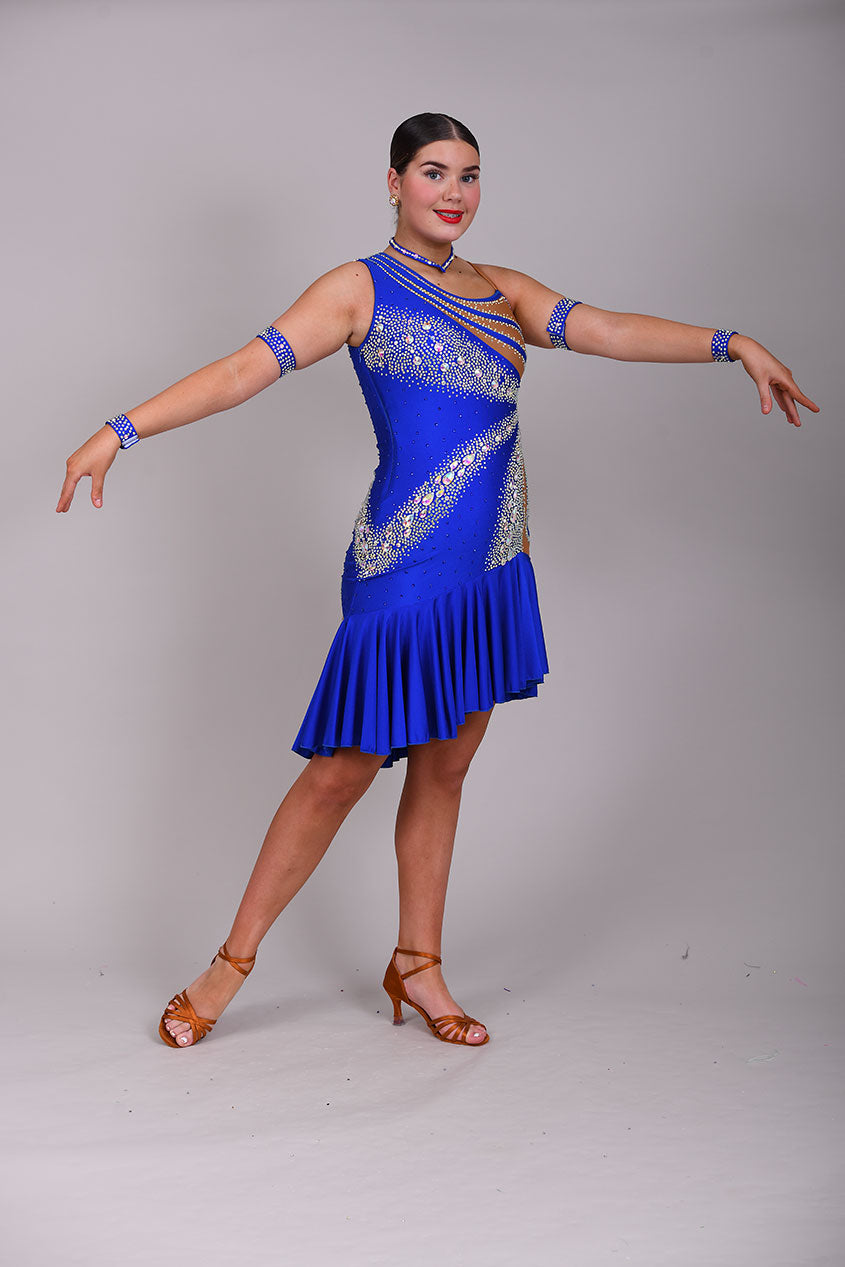 138 Bright Electric Blue One Shoulder Latin Dress. Tan Lycra to one side & heavily stoned in AB. Full frill effect skirt.