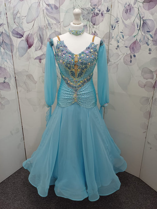 72B TWD Petite Beautiful Blue Competition Ballroom/Sequence Dance Dress. Heavy appliqué stoning to upper chest in Light Sapphire & AB. Separate puff arms with detachable wrist floats. ❤️Showroom Appointments Available❤️