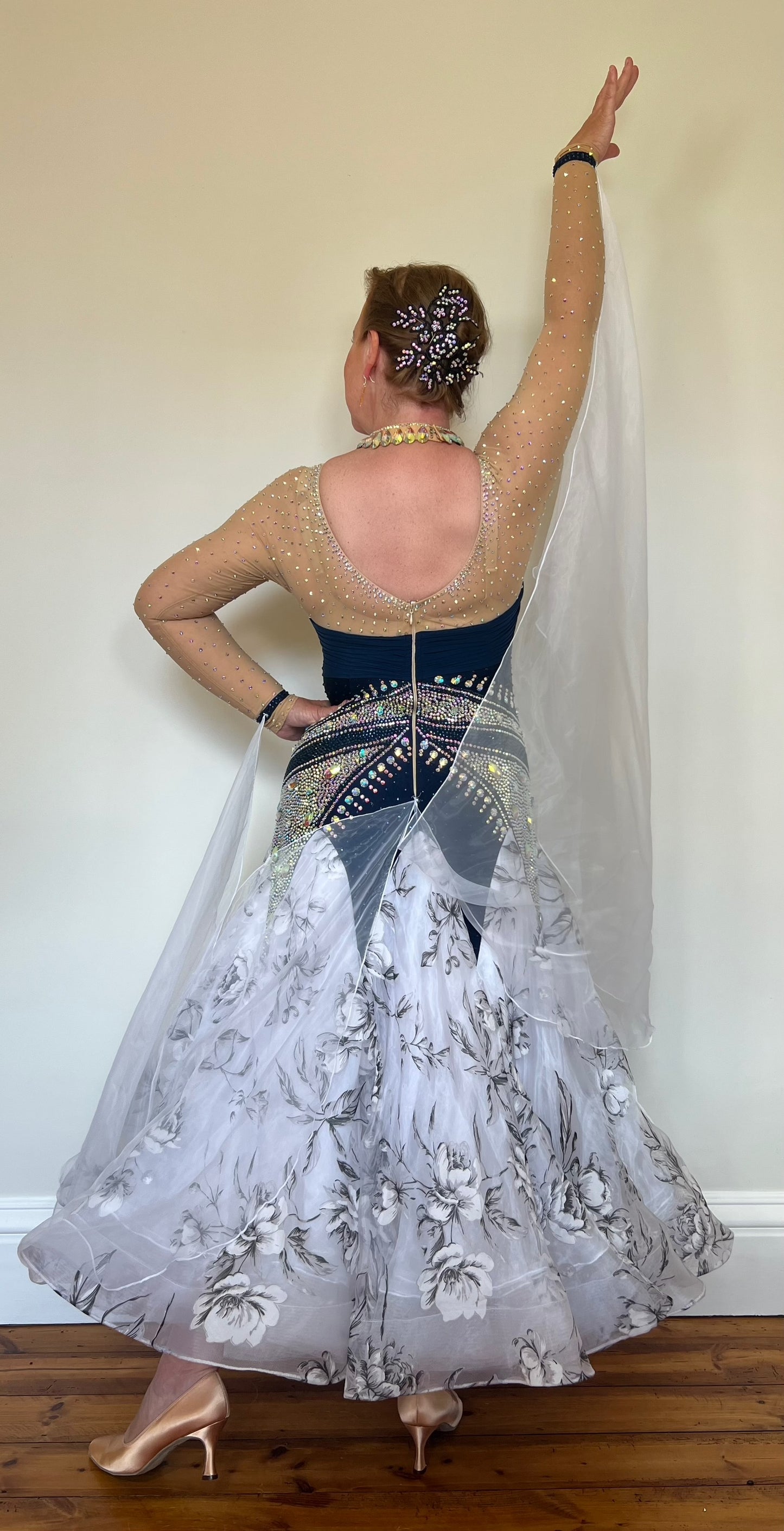 149 Navy & Flesh Bodice with beautiful Floral Organza Skirt Ballroom Dress. Heavily stoned in AB with floats at the wrist & back.