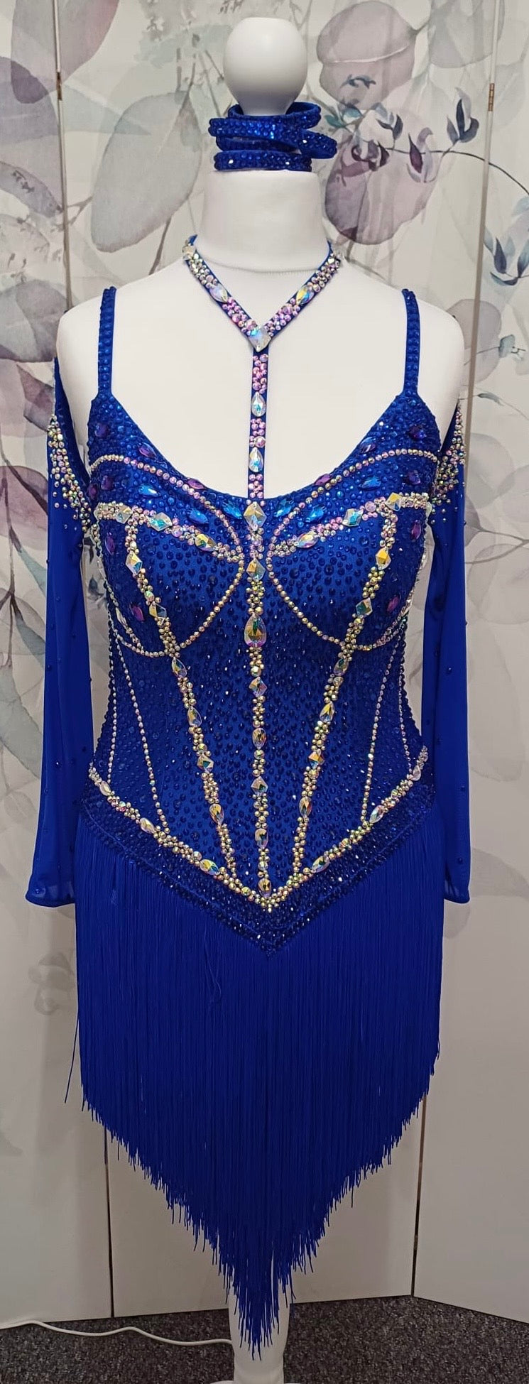 014 Royal blue Competition Latin Dance Dress. Heavily stoned in AB & Sapphire. Full fringed skirt for maximum movement. Neck detailing. Comes with long stoned gloves & Bracelets