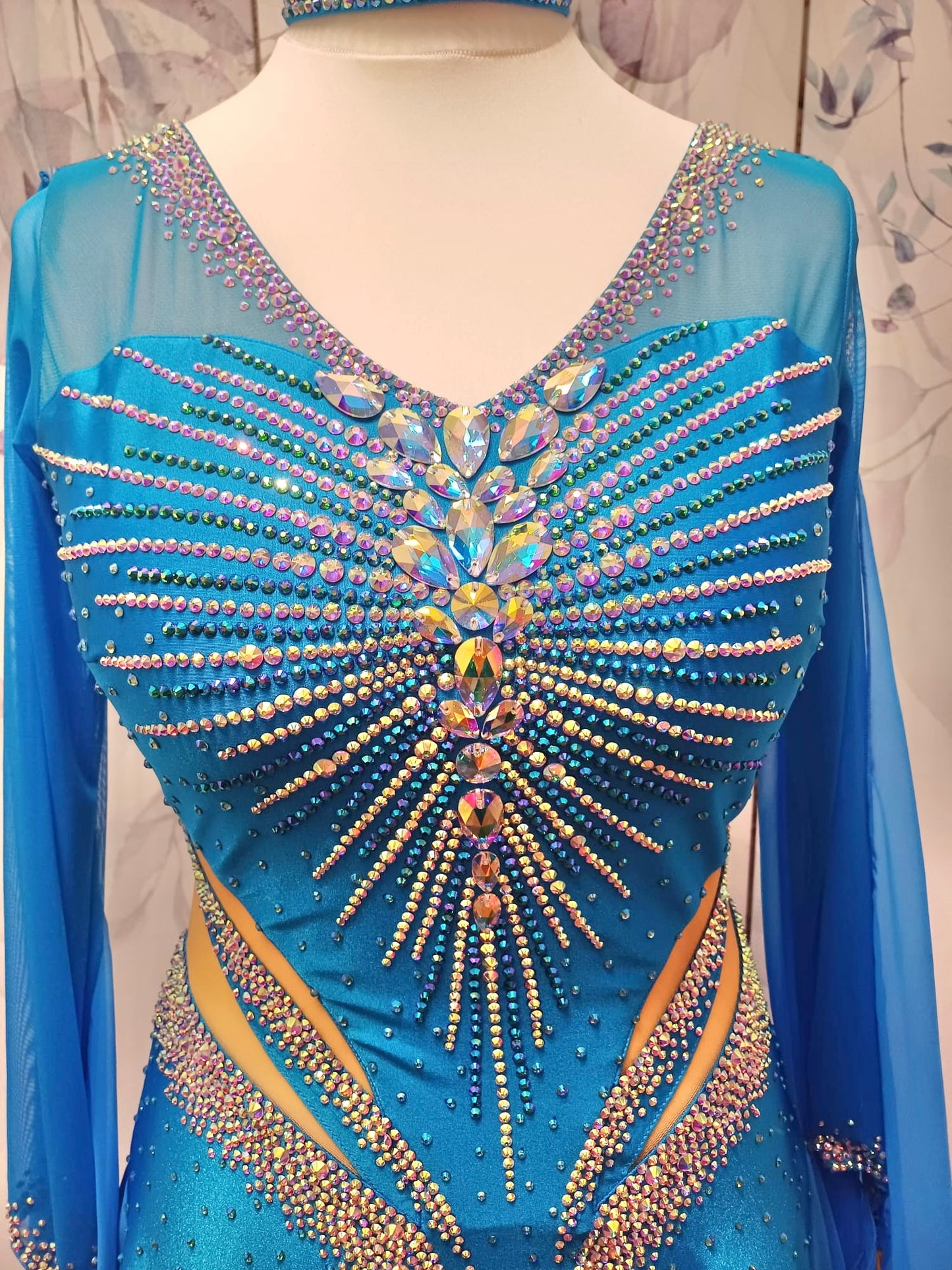 094 Turquoise Competition Ballroom Dance Dress heavily decorated heavily decorated with AB & Capri Blue Stones. Flattering stoned strap detailing detailing to the waist area. High back to give option to wear own bra. Detachable floats