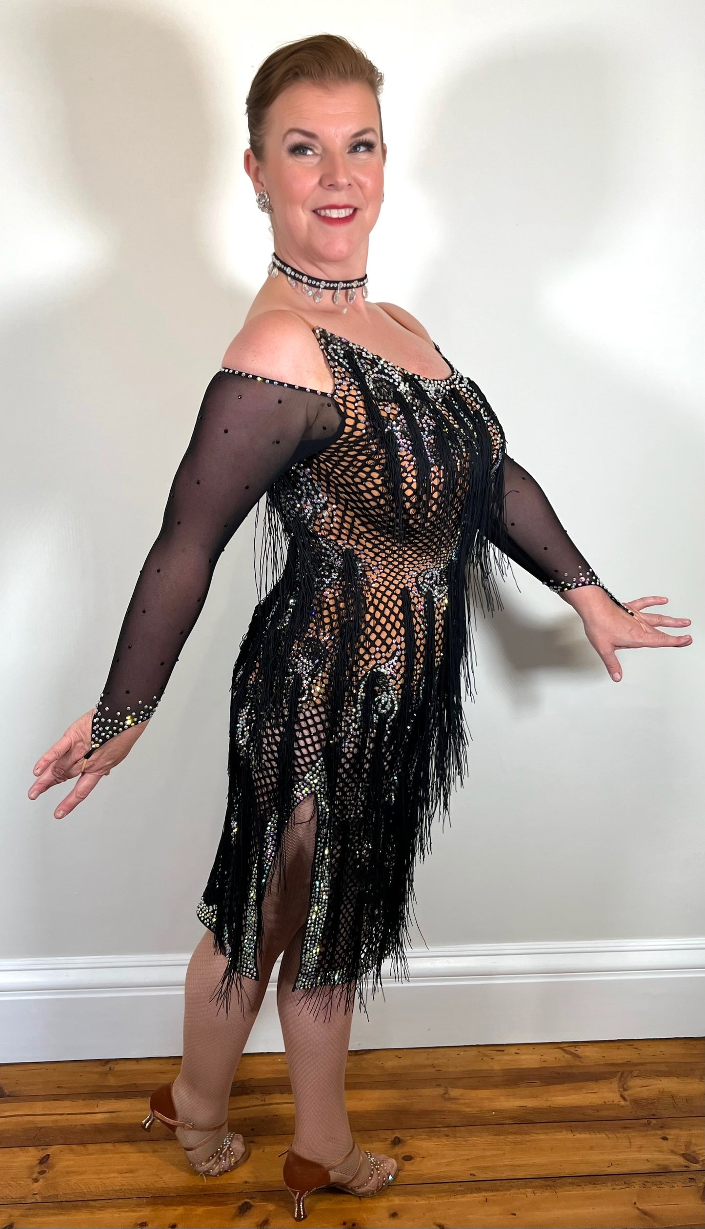 068 Black & Tan Wide fishnet Competition Latin Dress. Hanging fringe all over. Heavily stoned in crystal golden shadow, topaz & AB. Cold shoulder detailing to one arm, full shoulder to other arm
