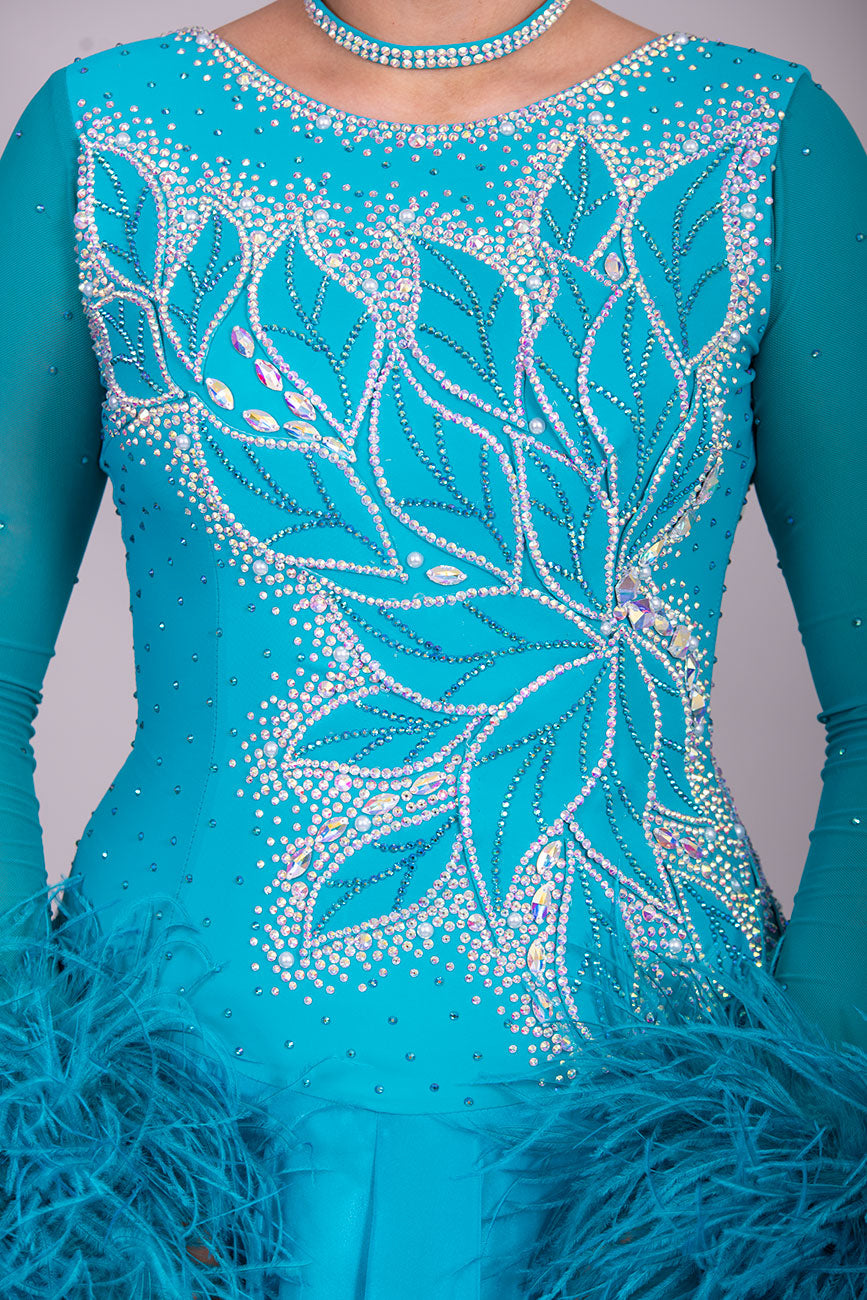 26B “TWD ELITE” Teal competition Ballroom/Sequence Dance dress. New Fuller skirts/Underskirts with 3D design to front and back. Stoned in AB & Blue Zircon. Detachable Ostrich Feather Floats