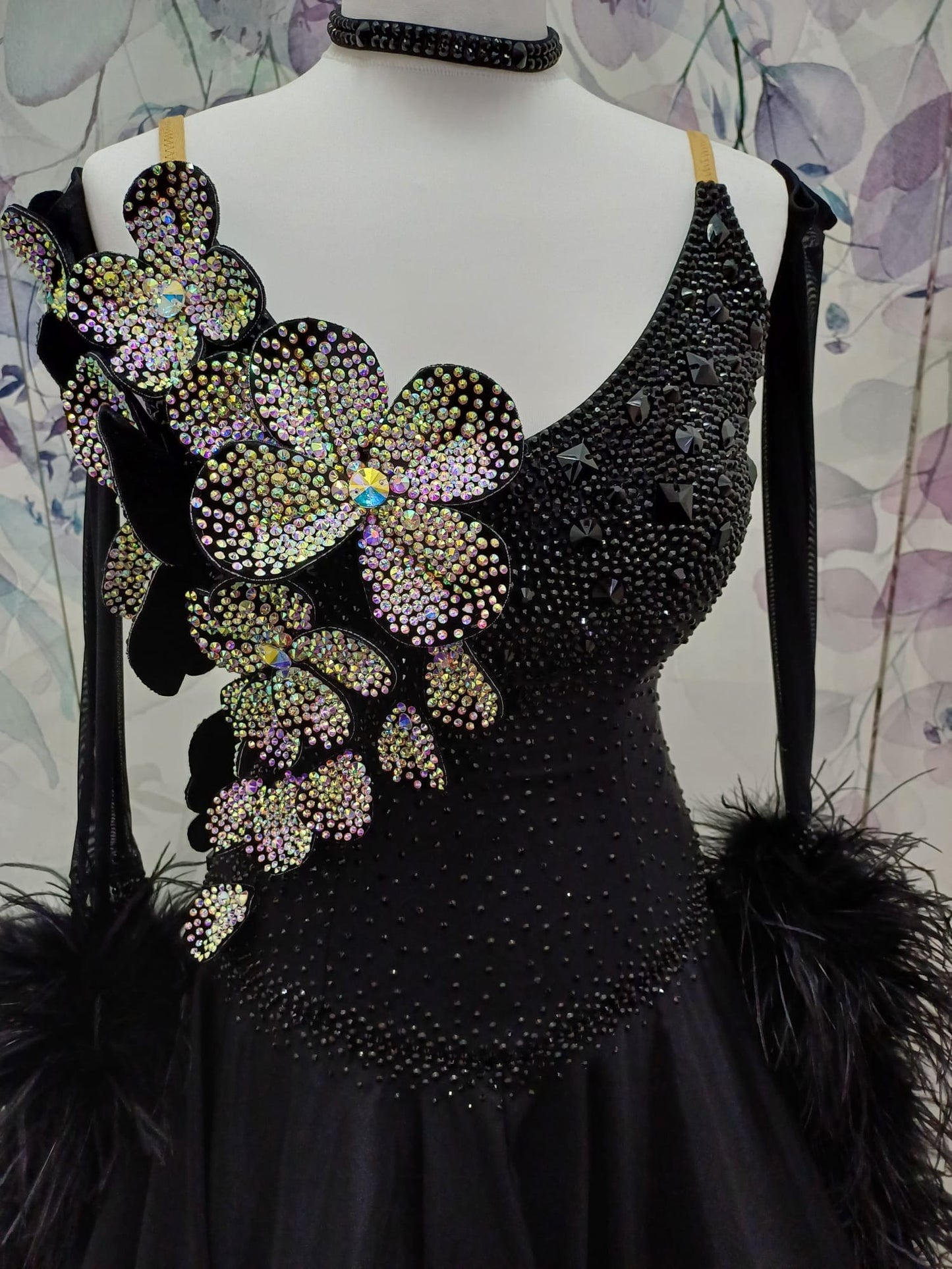 57B TWD “ELITE” Striking Black Ballroom/Sequence Competition Dance Dress. 3D Flowers heavily stoned in AB with Jet stoning throughout. Detachable Ostrich Feather Floats & Long Gloves ❤️Showroom Appointments Available❤️