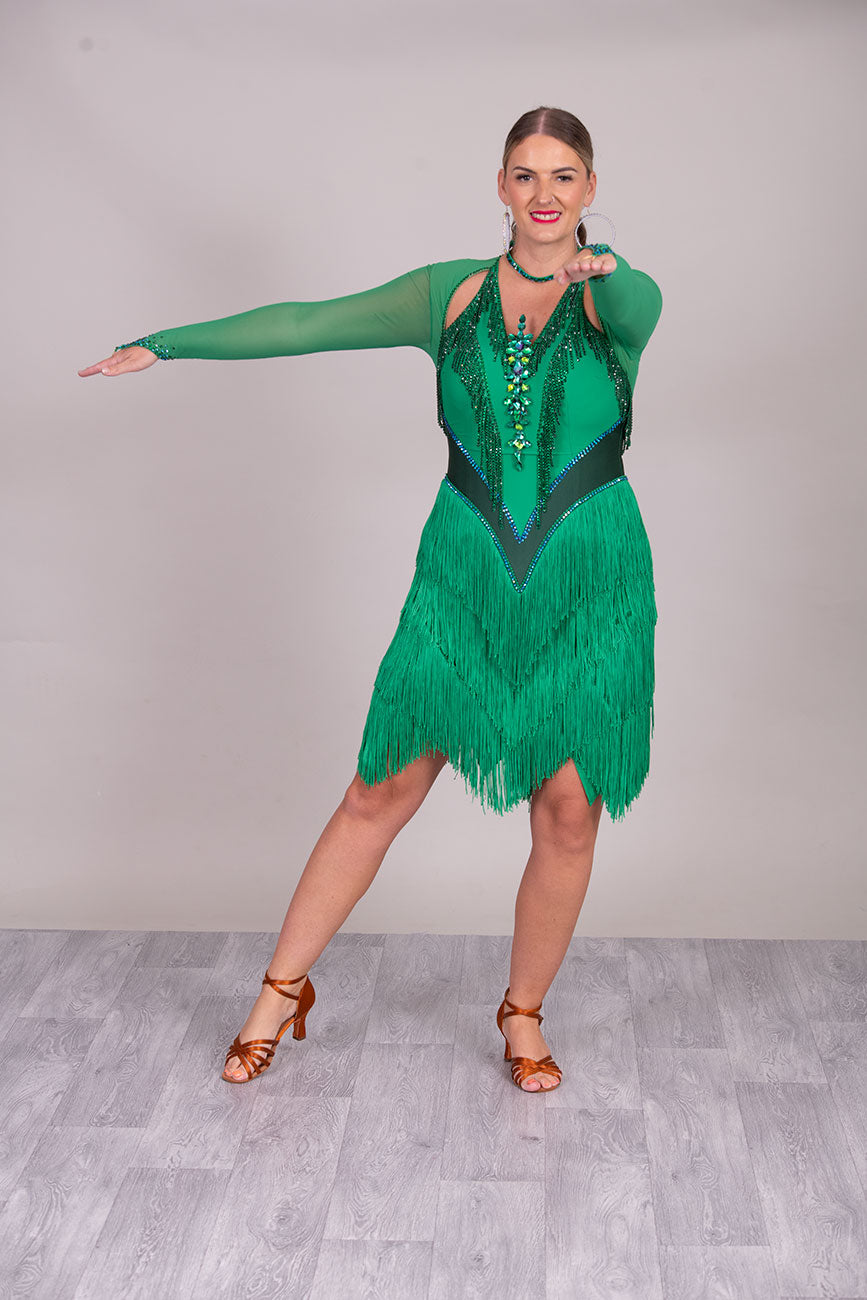 114L Deep Green Competition Latin Dance dress. Stunning Stone detail to the Front with open Detailing on the shoulder. Very Full fringed skirt