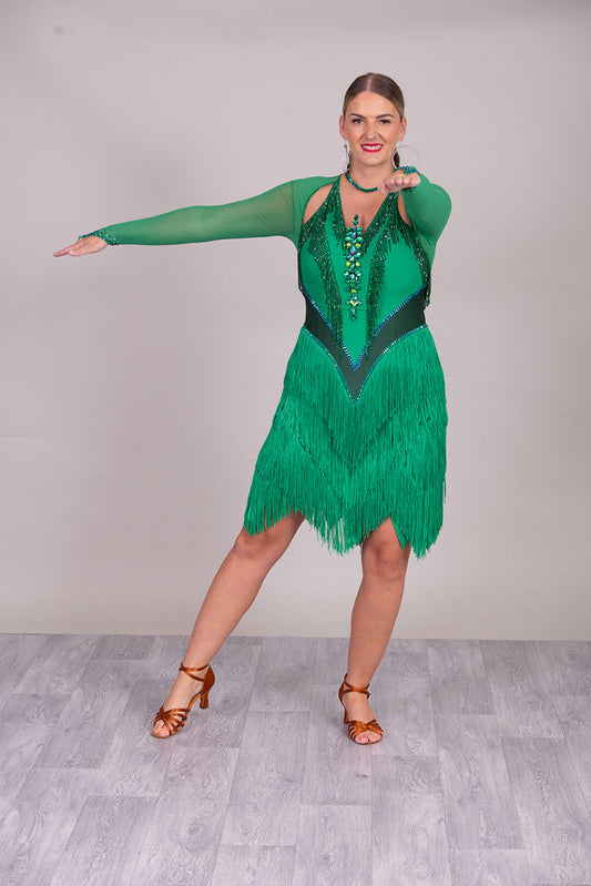114L Deep Green Competition Latin Dance dress. Stunning Stone detail to the Front with open Detailing on the shoulder. Very Full fringed skirt