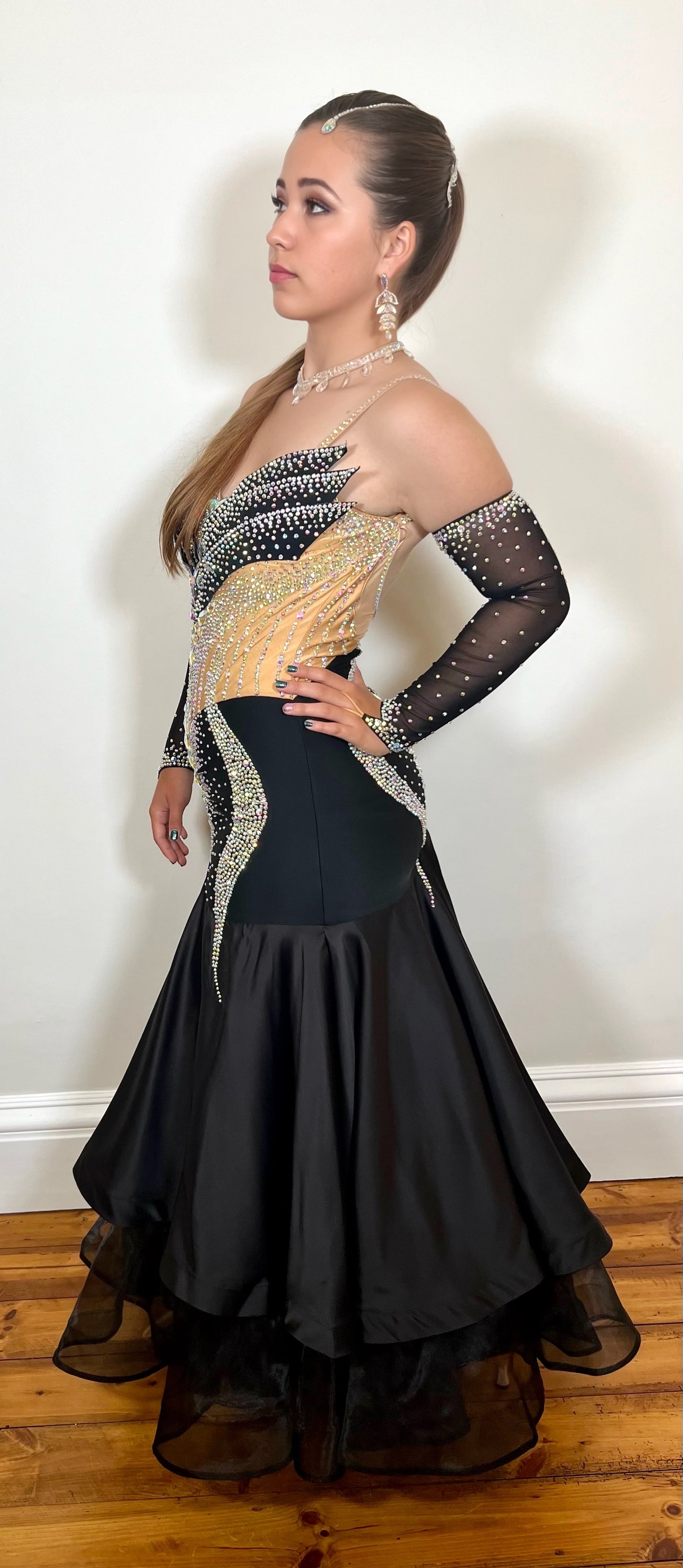 166 Striking Black layered skirt Ballroom Dress. Decorated with AB stones on a structured bodice. Flesh panelling & stunning detail throughout. Stoned gloves