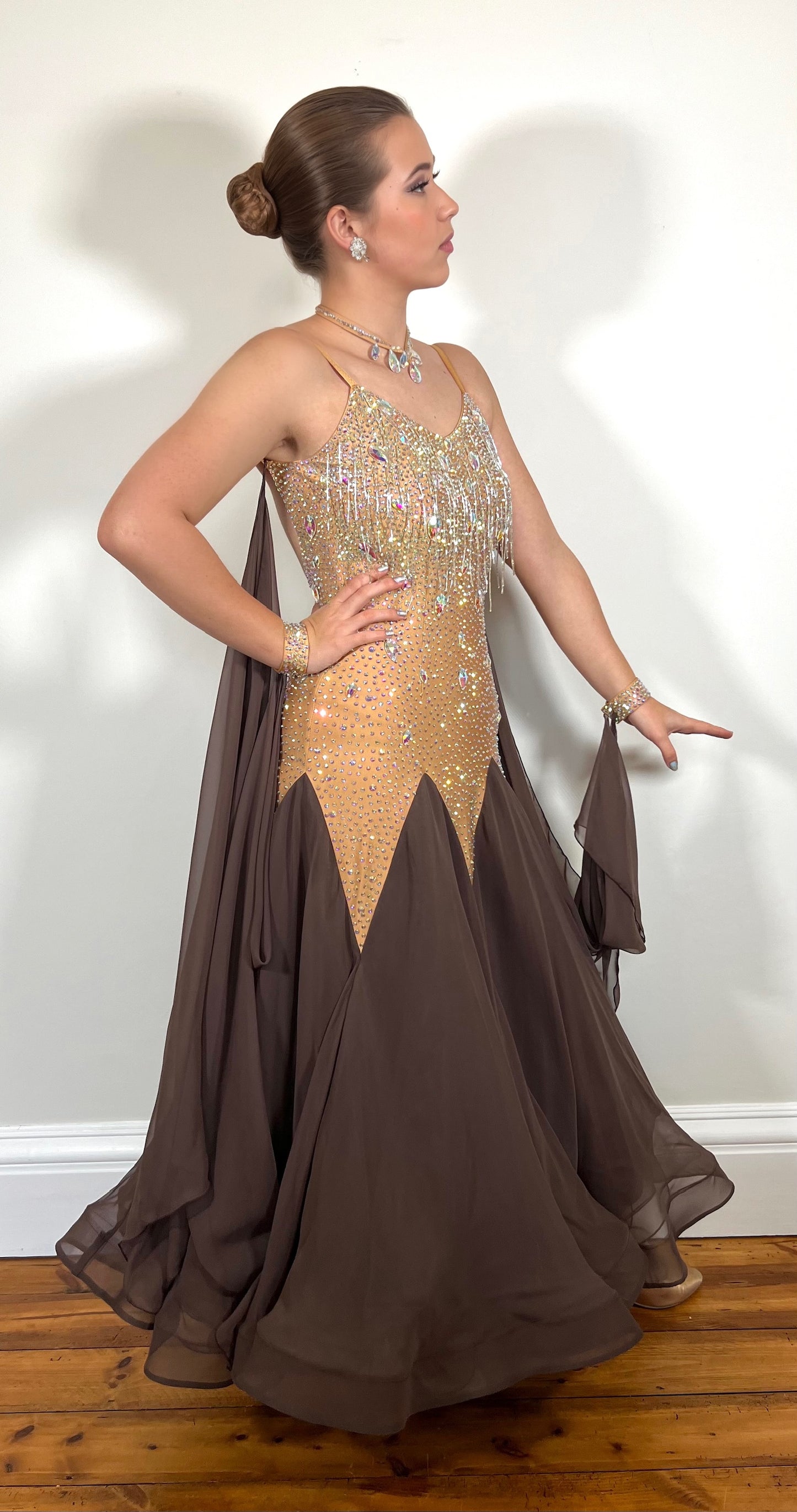 0001 Light Gold & Chocolate Sleeveless Ballroom Dress. Chocolate detachable floats to stoned cuffs. Decorated with bead droppers & AB stones.