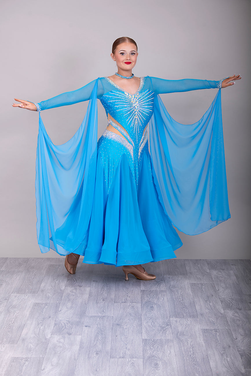094 Turquoise Competition Ballroom Dance Dress heavily decorated heavily decorated with AB & Capri Blue Stones. Flattering stoned strap detailing detailing to the waist area. High back to give option to wear own bra. Detachable floats