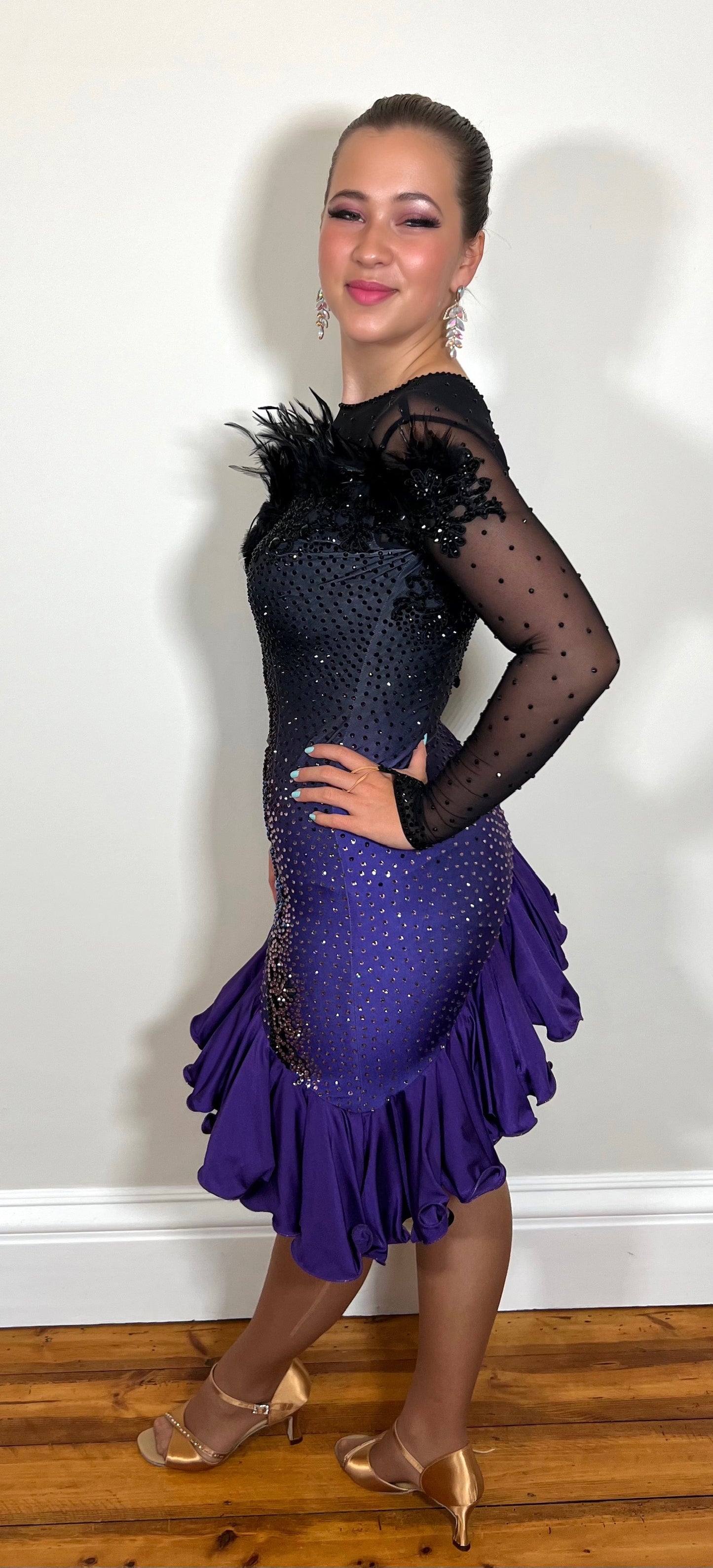 194 Standout Latin Dance Dress. Black to purple ombre with full frill skirt. Decorated with ostrich feather trim, purple & jet stones.