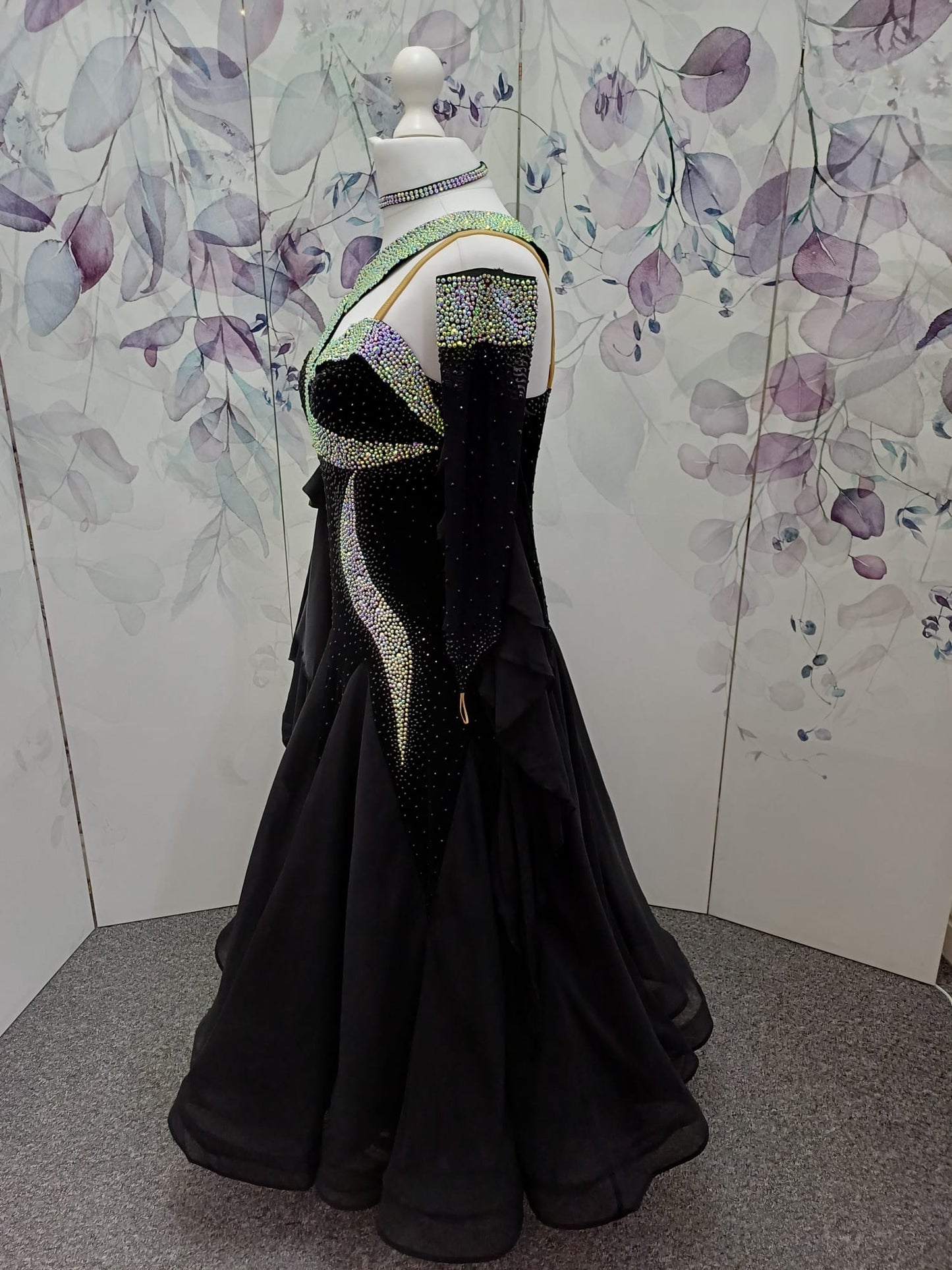 64B Classic Black Competition Ballroom dance dress. Flattering design heavily stoned in AB & Jet. Detachable floats. Satin frill to the front right bodice. Back high enough to wear own bra.