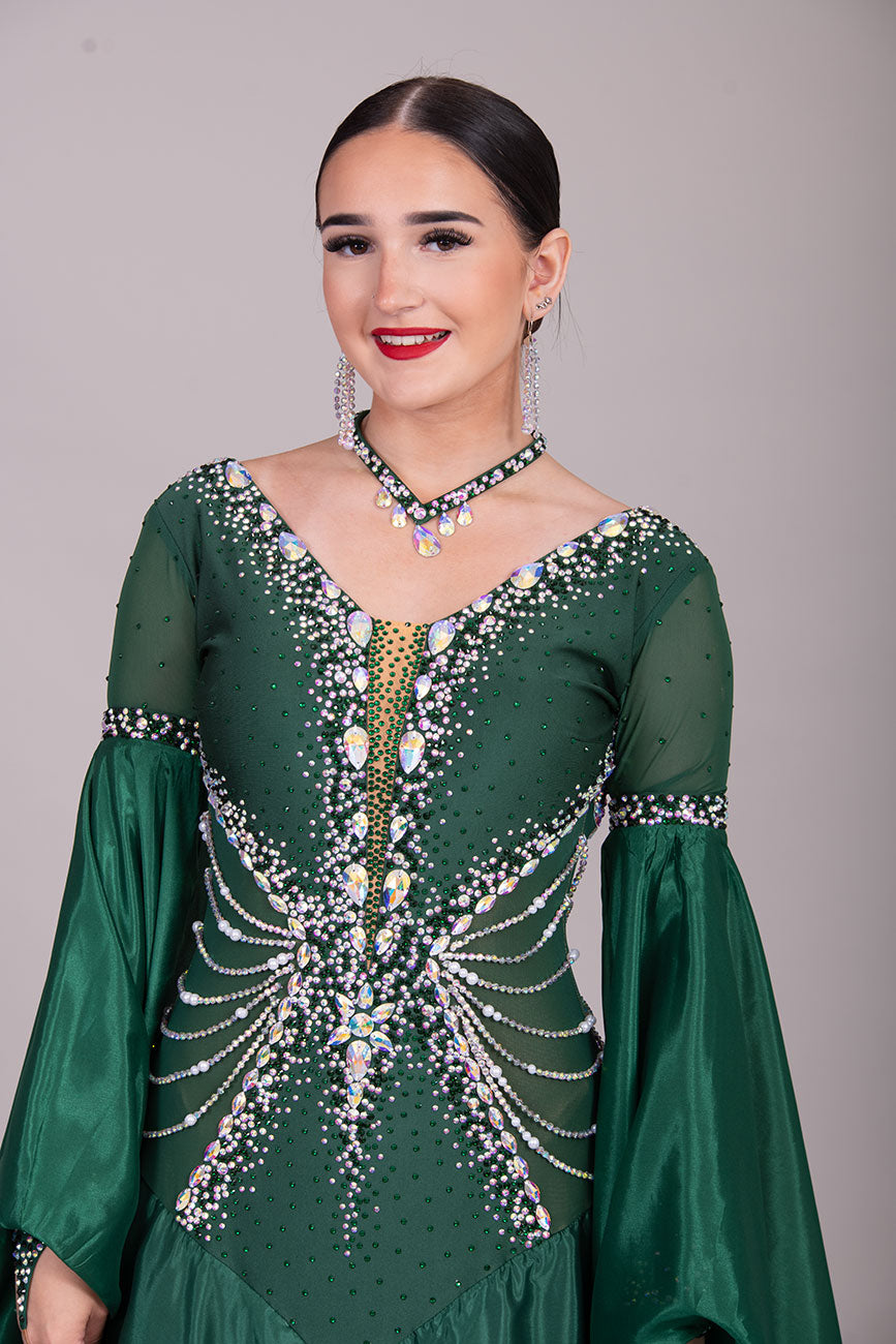 50B TWD “PETITE” Jade Green Competition Ballroom Dance Dress. Beautiful hanging strap detail on the hips. Heavily stoned in AB & Emerald & pearls. Bell sleeves. ❤️Showroom Appointments Available❤️