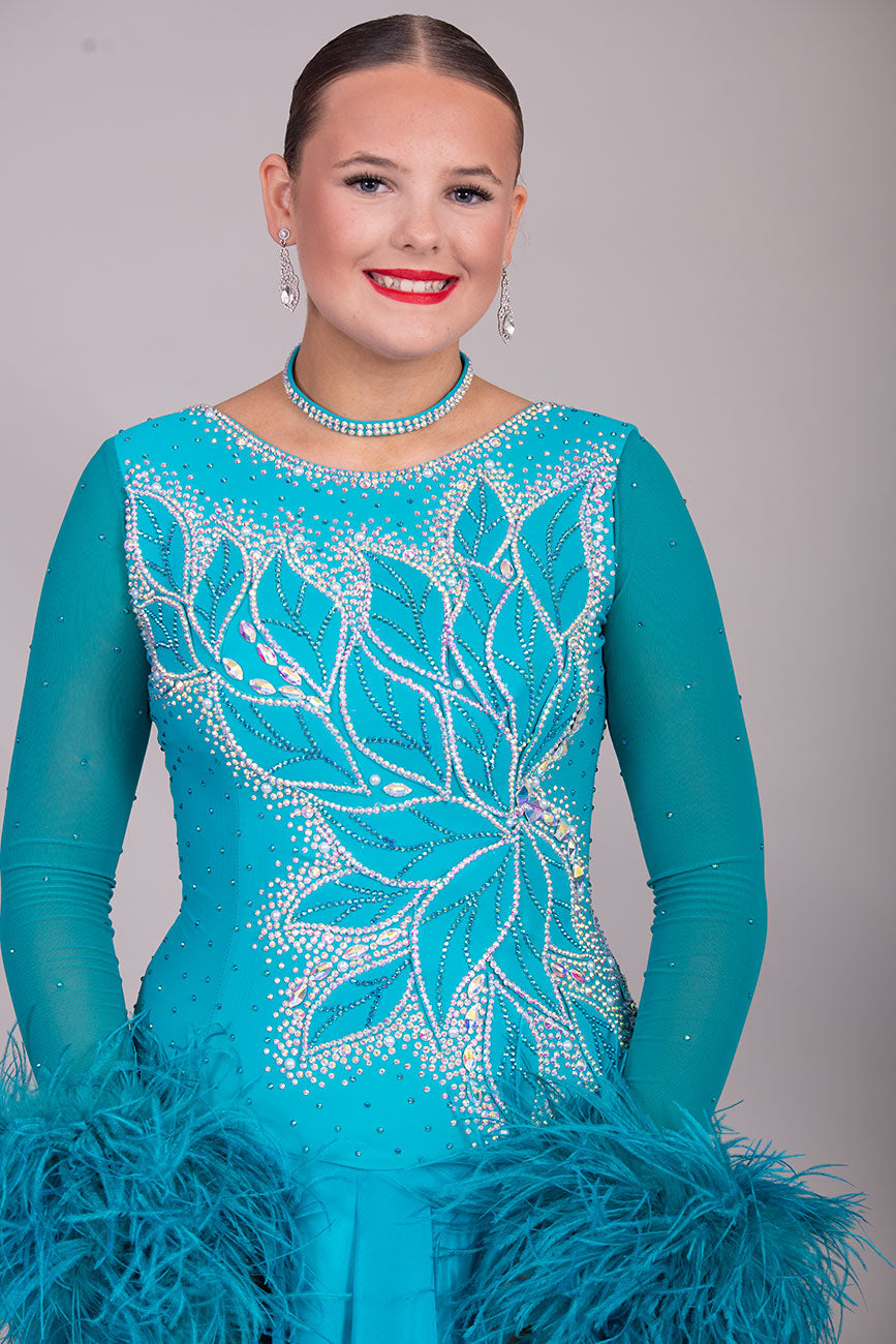 26B “TWD ELITE” Teal competition Ballroom/Sequence Dance dress. New Fuller skirts/Underskirts with 3D design to front and back. Stoned in AB & Blue Zircon. Detachable Ostrich Feather Floats