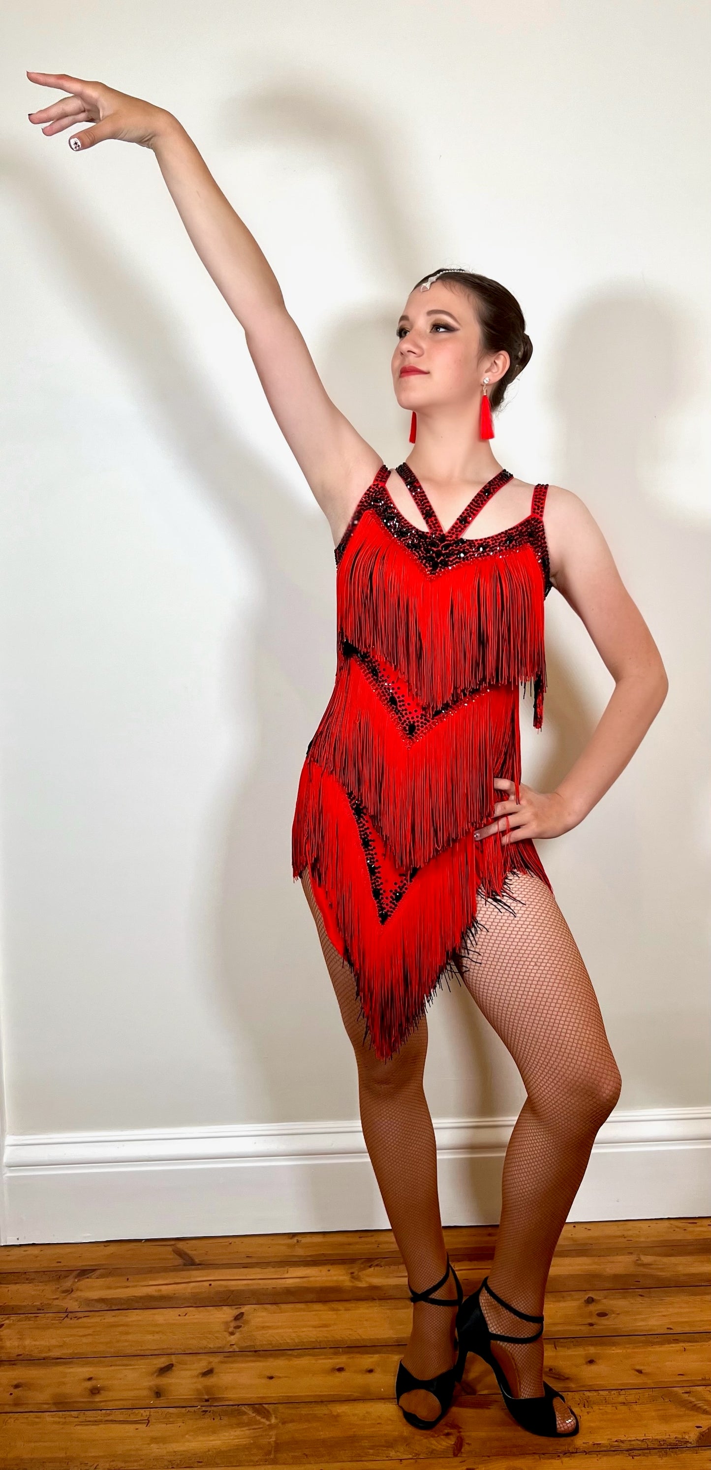 350 Multi Layered Fringe Black & Red Latin Dress. Neck detailing and detachable belt. Decorated in Jet & Siam stones.