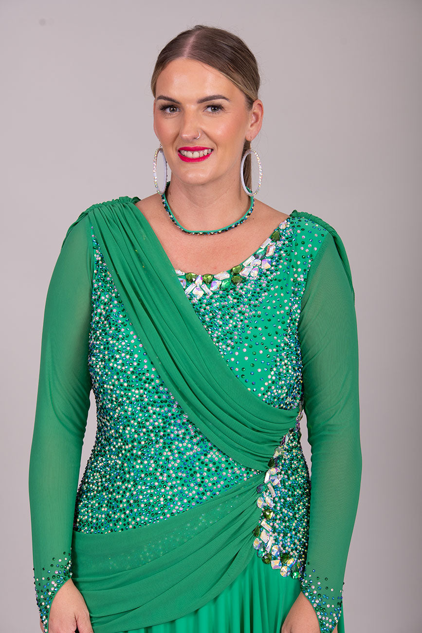 115L Emerald Green Competition Latin Dance Dress. Stunning dense stoning in AB, Emerald & Emerald AB. Sash details to the chest & Hip. High Back to give option of wearing own bra