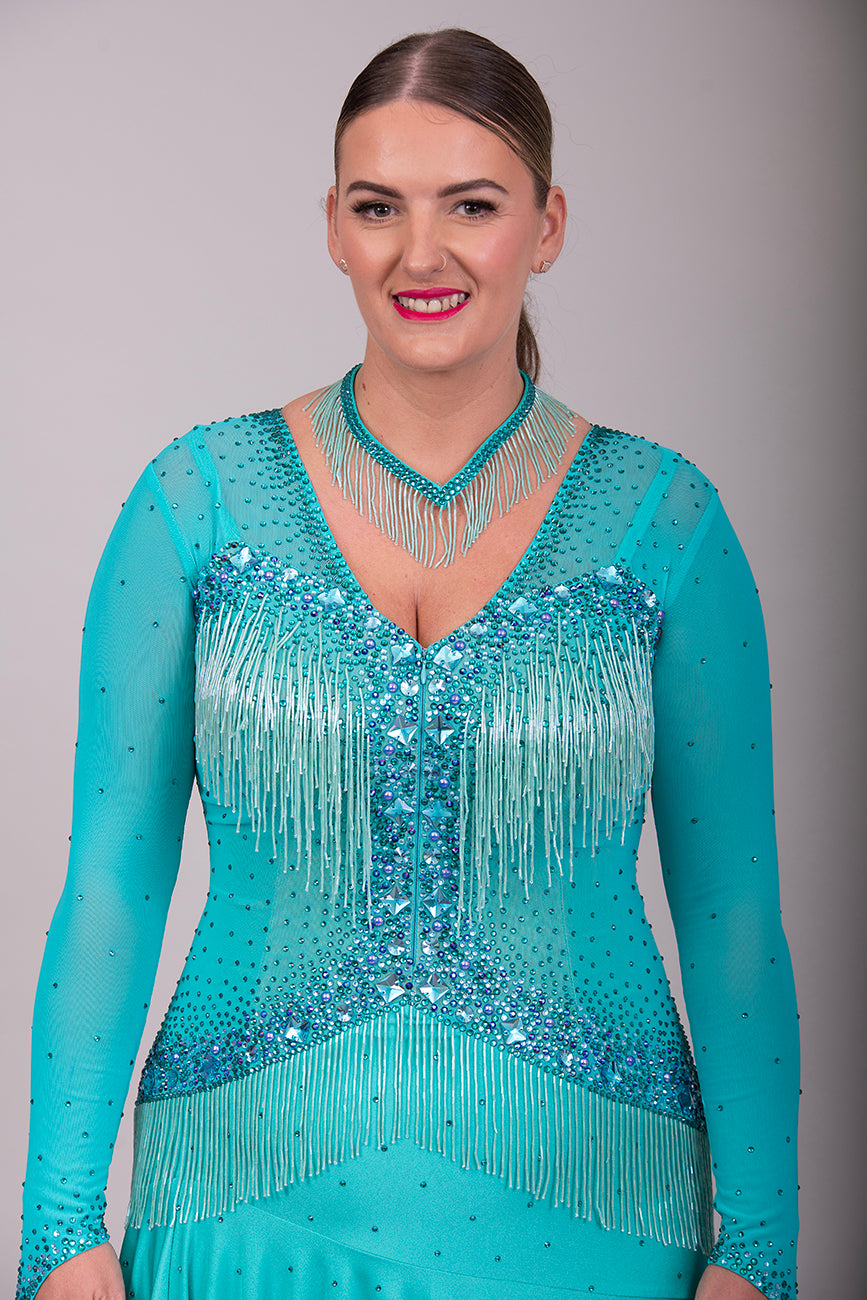0101 Latin Dance Dress. Very full skirts giving maximum movement. Beading to the chest & waist area. Bodice back & front mesh with flesh under to allow the option to wear own Bra. Stunning stoning detail.