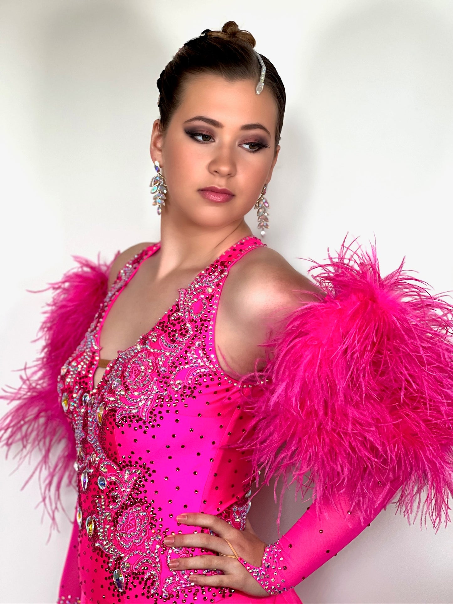 139 Stunning Bright Pink Ballroom dress. Comes with long pink mesh fingerloop gloves and Fluffy ostrich feather cuffs. Decorative back. Stoned in AB, Rose & Light Rose