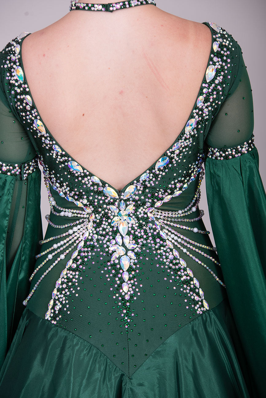 50B TWD “PETITE” Jade Green Competition Ballroom Dance Dress. Beautiful hanging strap detail on the hips. Heavily stoned in AB & Emerald & pearls. Bell sleeves. ❤️Showroom Appointments Available❤️