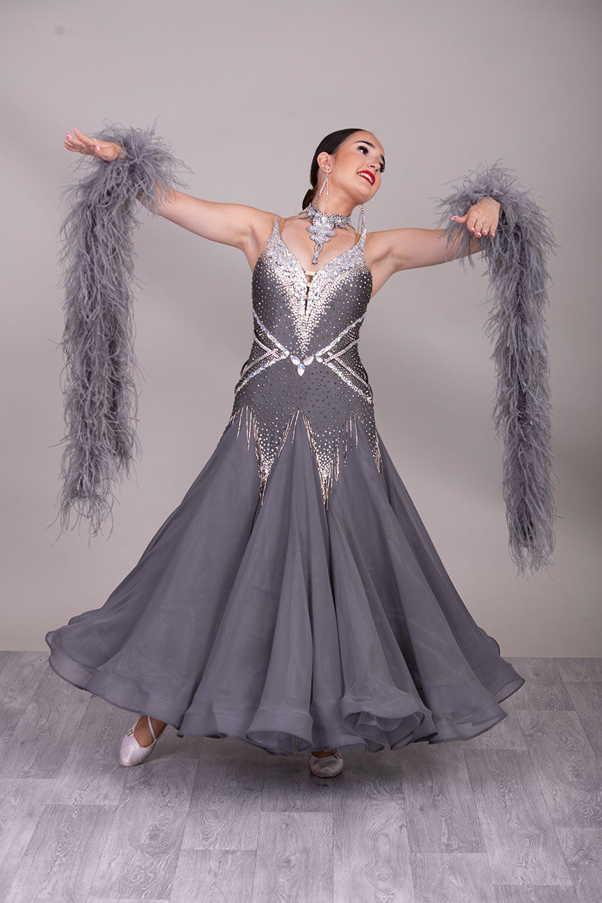 22B “TWD ELITE” New Fuller Skirts/Underskirts Pale grey Ballroom/Sequence Competition Dance Dress. Stunning stone design in Crystal with 3D features to the upper bodice and sides. Detachable Ostrich feather Floats with hanging back detail.