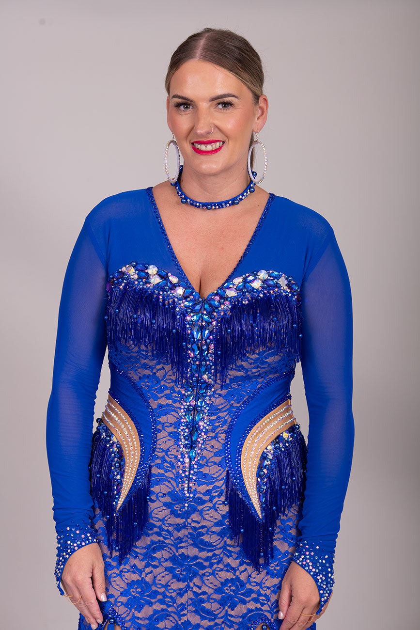 128L TWD “ELITE” Stunning Royal Blue Competition Latin Dance Dress. Striking stone detail with lace over mesh Lycra. Front Zip fastening for ease. High back mesh on Lycra giving option of wearing own bra. ❤️Showroom Appointments Available❤️