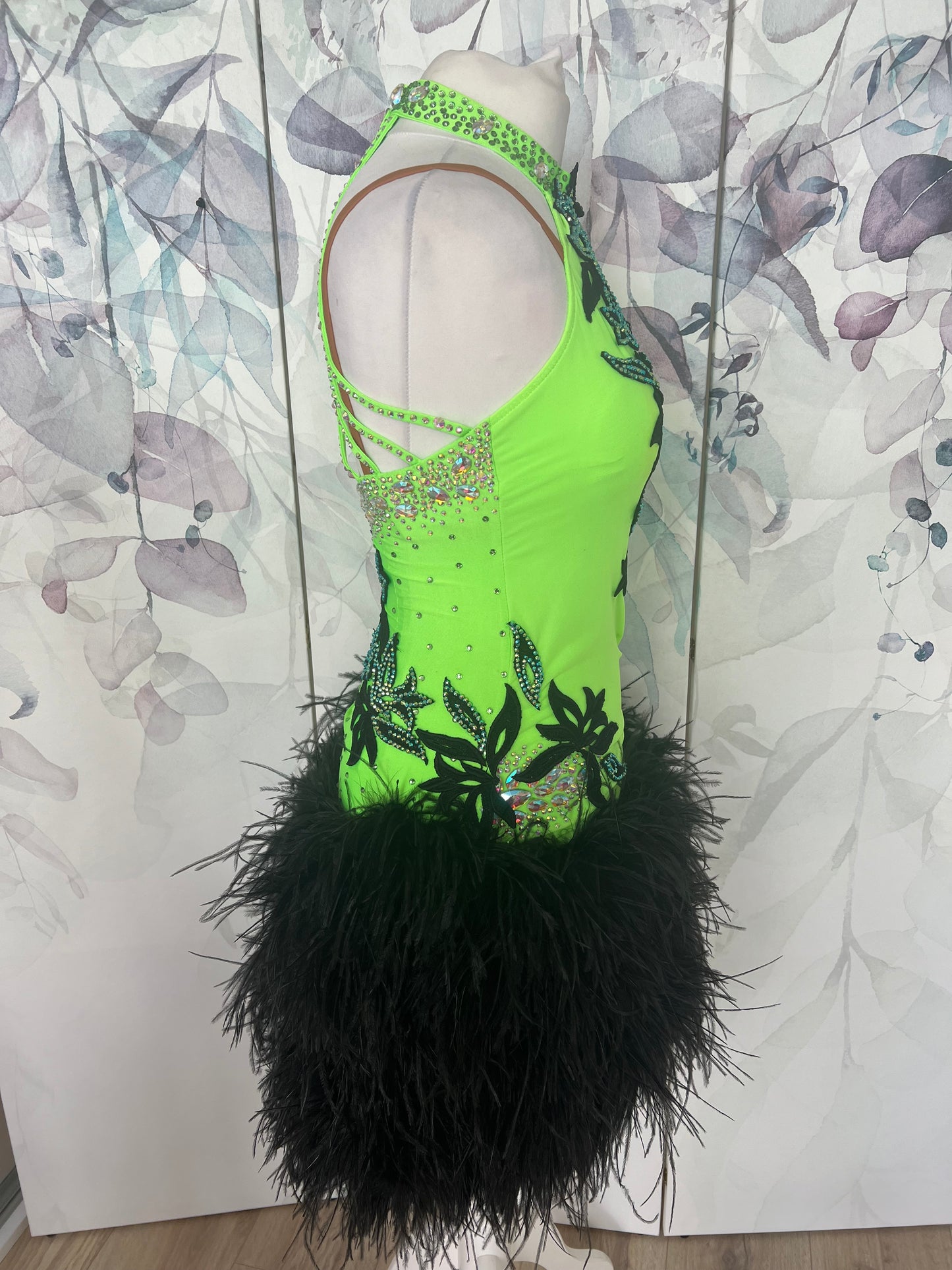 343 Flo Green & Black Latin Dress with keyhole halter neck detail. Strapping design to the back. Full ostrich feather skirt. Decorated with black motifs & stoned in Het AB & AB