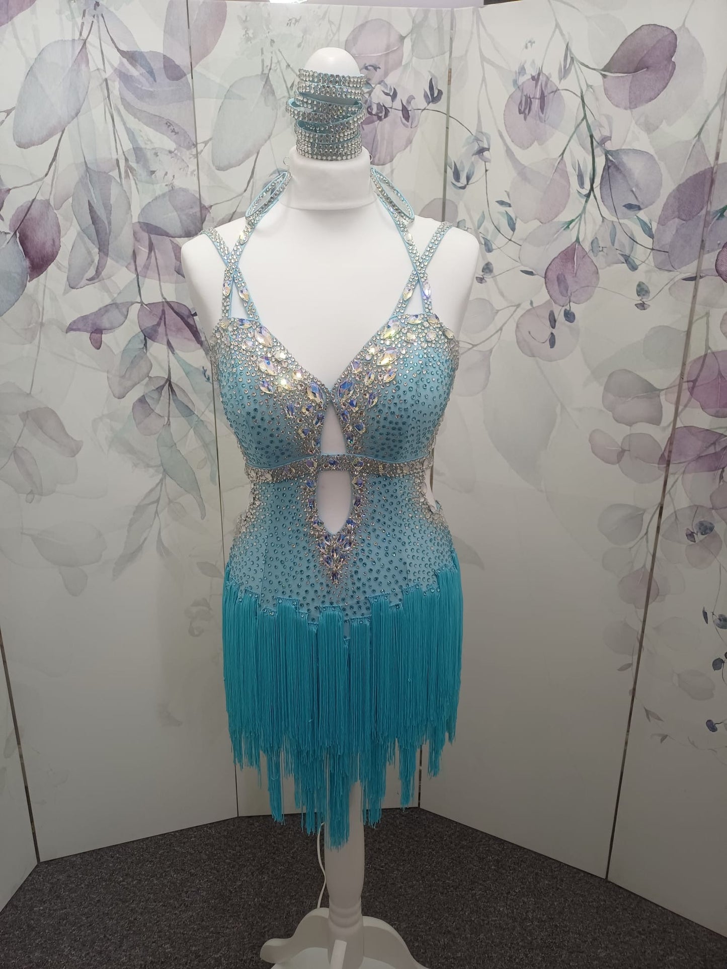 47L Paradise Blue Competition Latin Dance Dress. Beautiful detailing throughout with open design & strap details to the front. Comes with 8 bangles & matching Earrings. ❤️Showroom Appointments Available❤️