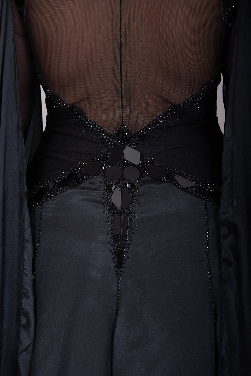 16B Black Ballroom/Sequence Competition Dance Dress. Heavily decorated in Black with Black Mirrors. Decoration continuing down into the Godet Points. A Stand Out & Sophisticated Dress