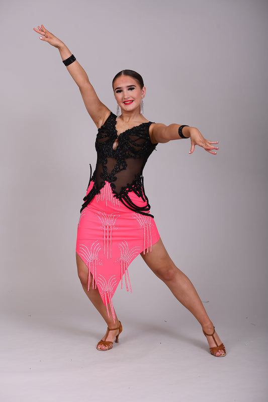 084 Black & Electric Pink Latin Dress. Black mesh bodice decorated with black appliqué & jet stones. Stoned material hip straps. Skirt decorated in AB