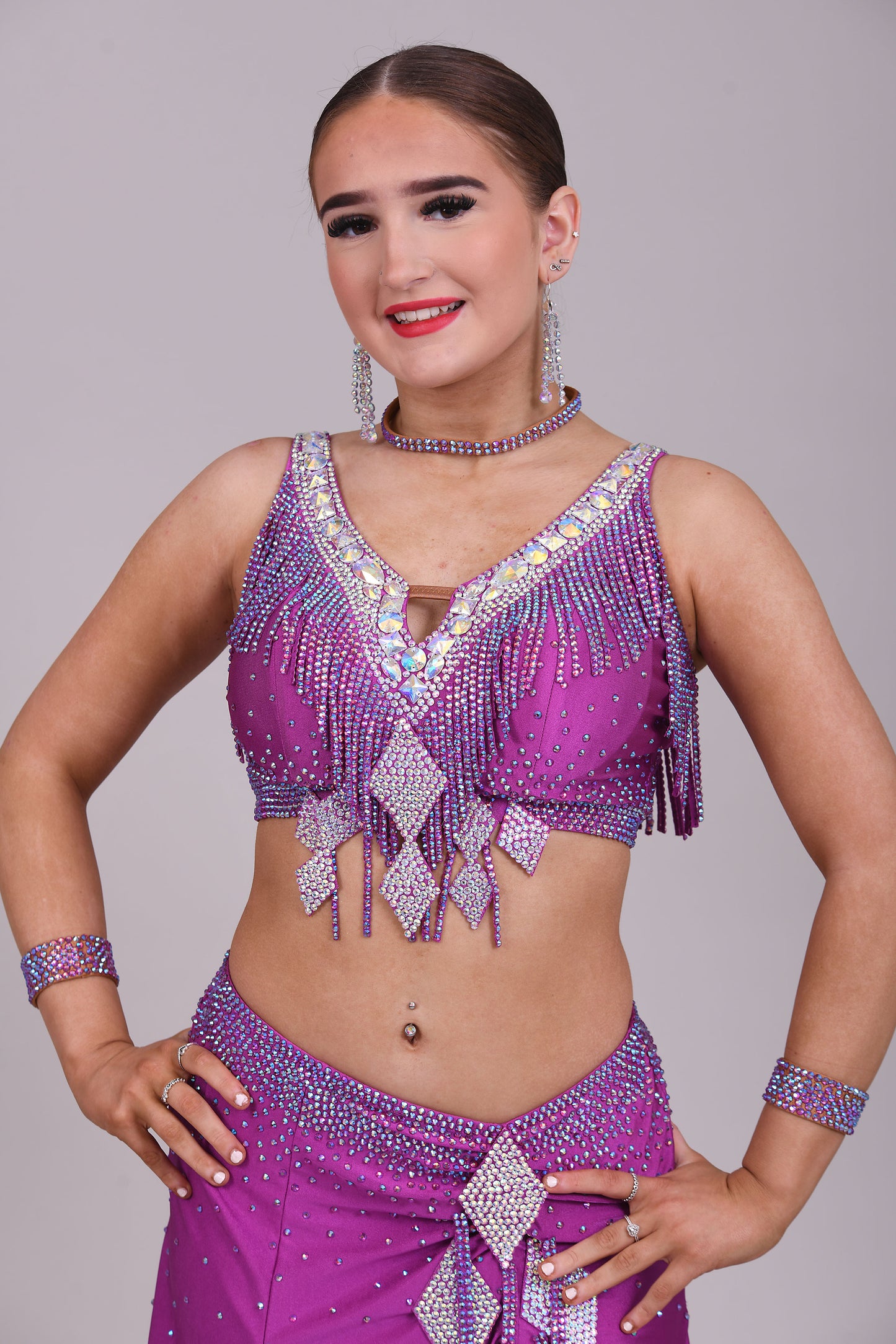 186 Stunning Latin 2 Piece. Full handkerchief skirt. Skirt comes with a choice of 2 tops. Stoned in Fuchsia AB & Fuchsia. Please add note at checkout choice of top required.