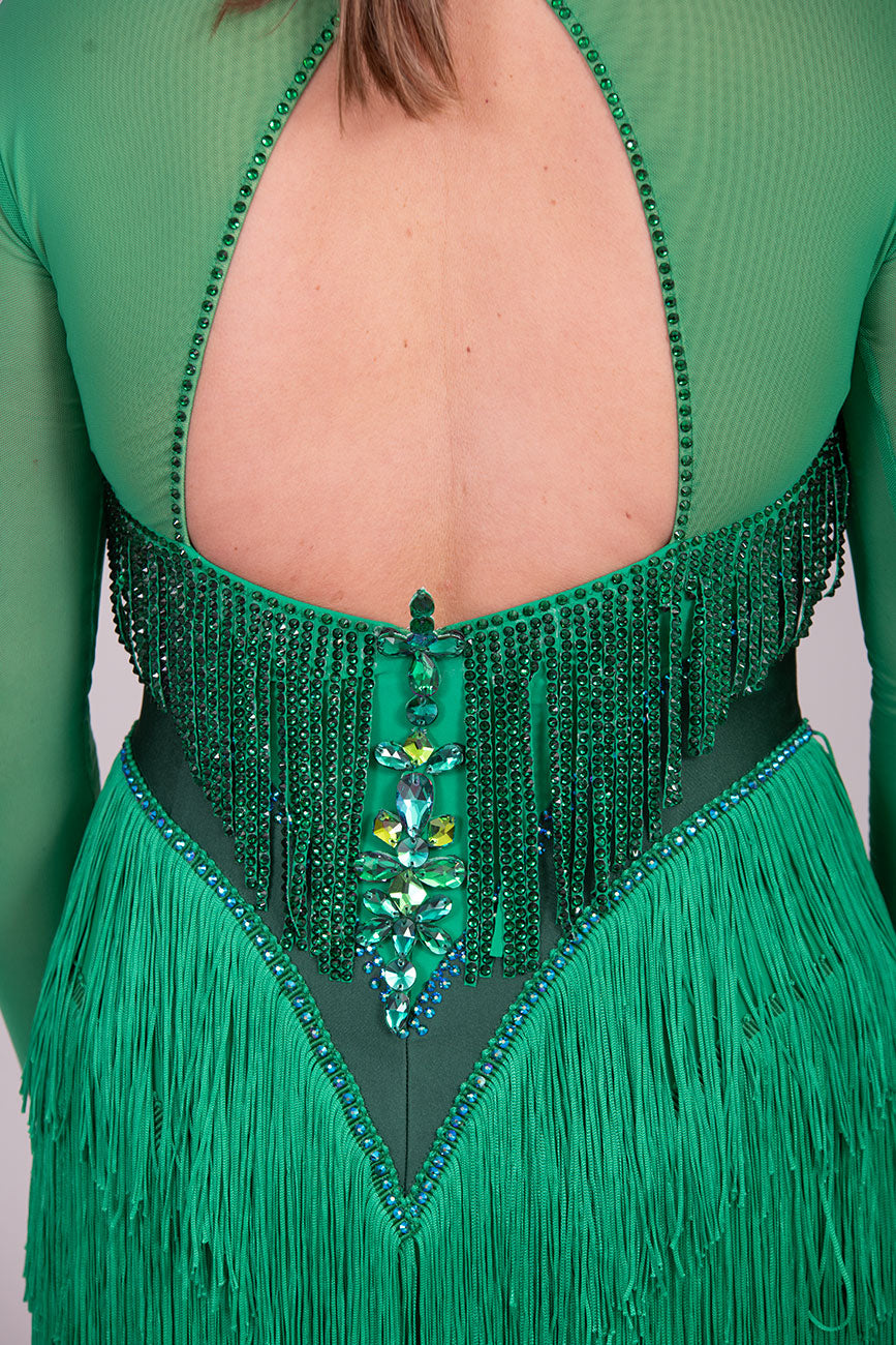 114L Deep Green Competition Latin Dance dress. Stunning Stone detail to the Front with open Detailing on the shoulder. Very Full fringed skirt