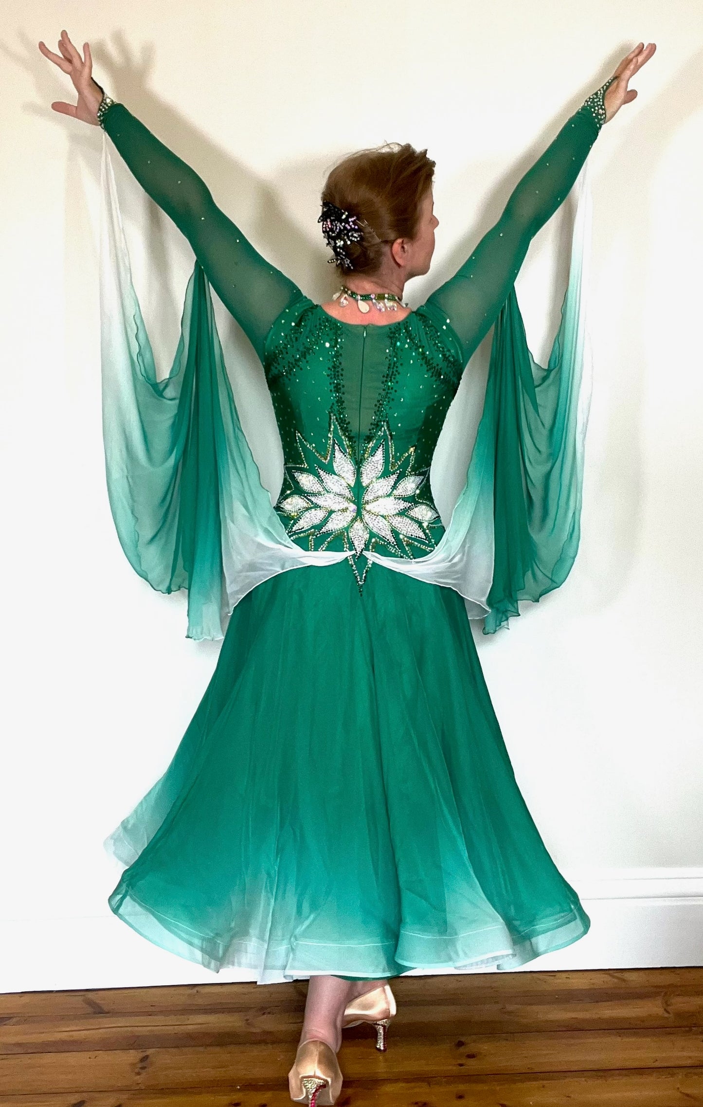 338 Emerald, Jade & White Ombré Ballroom Dress. Stunning decoration the the waist in White decorated with gold & AB stones. Dress decorated with light & dark green stones. Ombré floats to the back & sleeves.