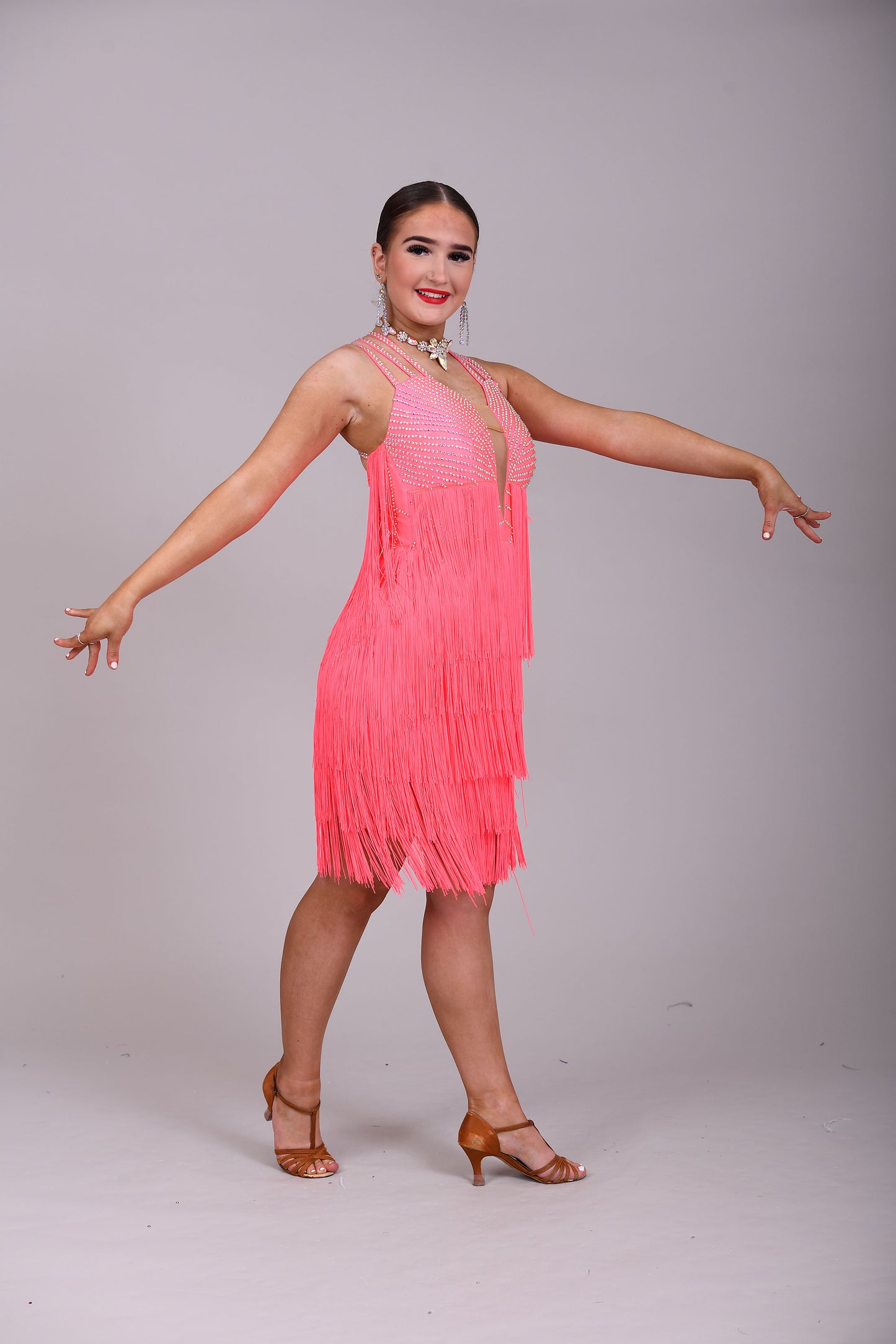 237 Bright Coral Fringed Dress. Decorated in AB stones with strapping detail to the shoulders & back. Matching Skirt, Floats & Belt available on request £135 extra