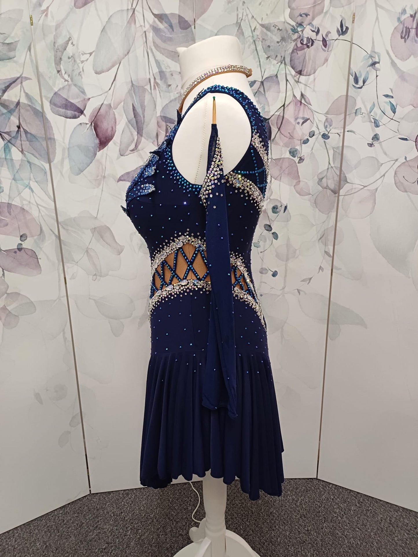 12L Navy Blue Competition Latin/Rhythm Dress. 3D Design to upper chest with flattering detailing to Hips. High back giving option to wear own Bra. Stoned in Blue, Blue AB & AB