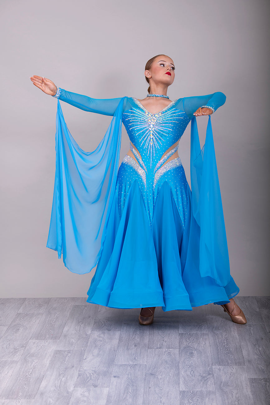 094 Turquoise Competition Ballroom Dance Dress heavily decorated heavily decorated with AB & Capri Blue Stones. Flattering stoned strap detailing detailing to the waist area. High back to give option to wear own bra. Detachable floats