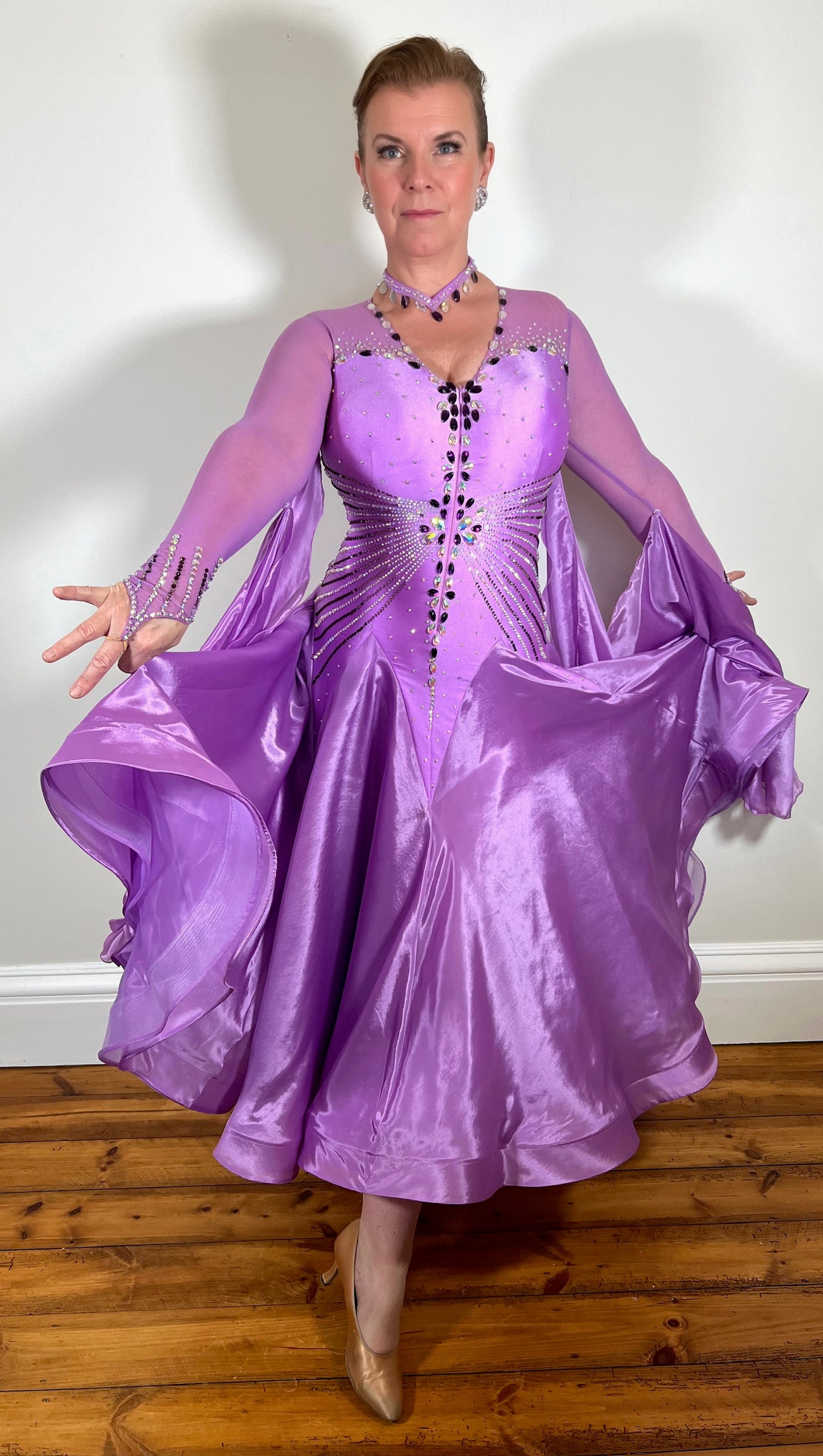 057 Lilac Dream Competition Ballroom Dance Dress. Comes with Detachable floats. High mesh on flesh Lycra back. Stoned in Purple velvet and AB