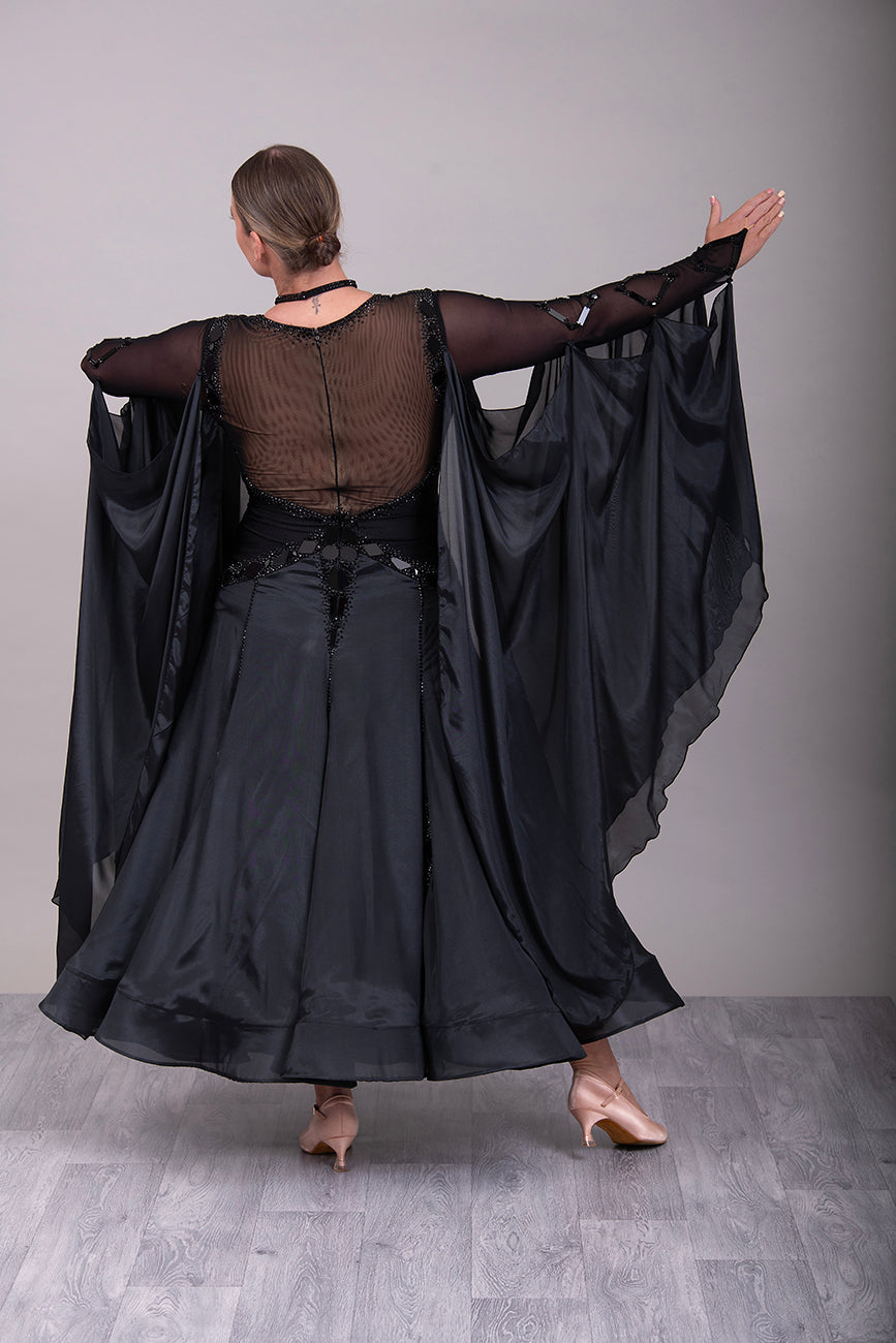 16B Black Ballroom/Sequence Competition Dance Dress. Heavily decorated in Black with Black Mirrors. Decoration continuing down into the Godet Points. A Stand Out & Sophisticated Dress