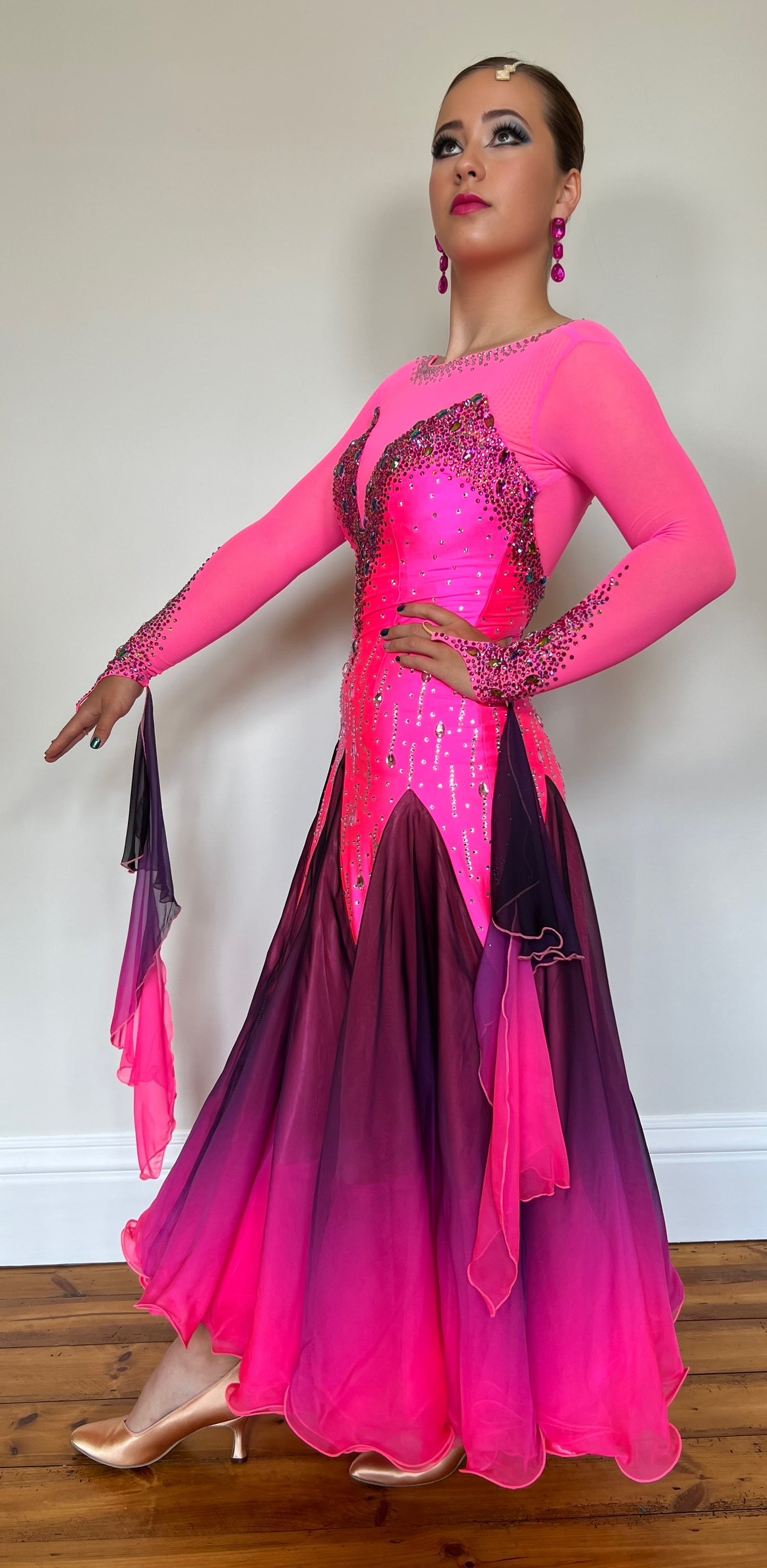 129 Electric Pink & Black Ombre Ballroom Dress. Decorated in Fuchsia & AB stones. Ombré floats from the wrist