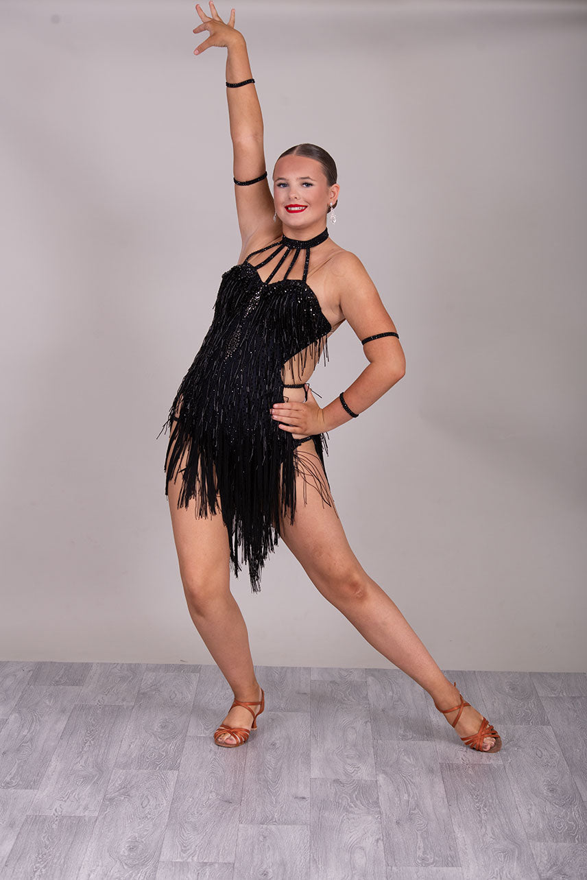 133L BUDGET (23) Black  Competition Latin Dance Dress. Beading detail to upper chest. Bead droppers with fringed skirt  Stoned in jet ❤️Showroom Appointments Available❤️