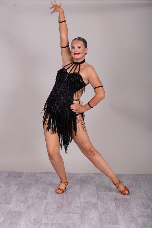 133L BUDGET (23) Black  Competition Latin Dance Dress. Beading detail to upper chest. Bead droppers with fringed skirt  Stoned in jet ❤️Showroom Appointments Available❤️