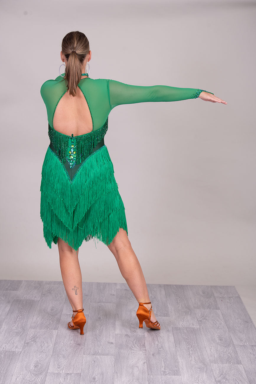 114L Deep Green Competition Latin Dance dress. Stunning Stone detail to the Front with open Detailing on the shoulder. Very Full fringed skirt