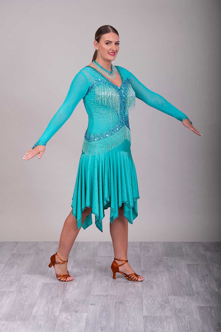 0101 Latin Dance Dress. Very full skirts giving maximum movement. Beading to the chest & waist area. Bodice back & front mesh with flesh under to allow the option to wear own Bra. Stunning stoning detail.