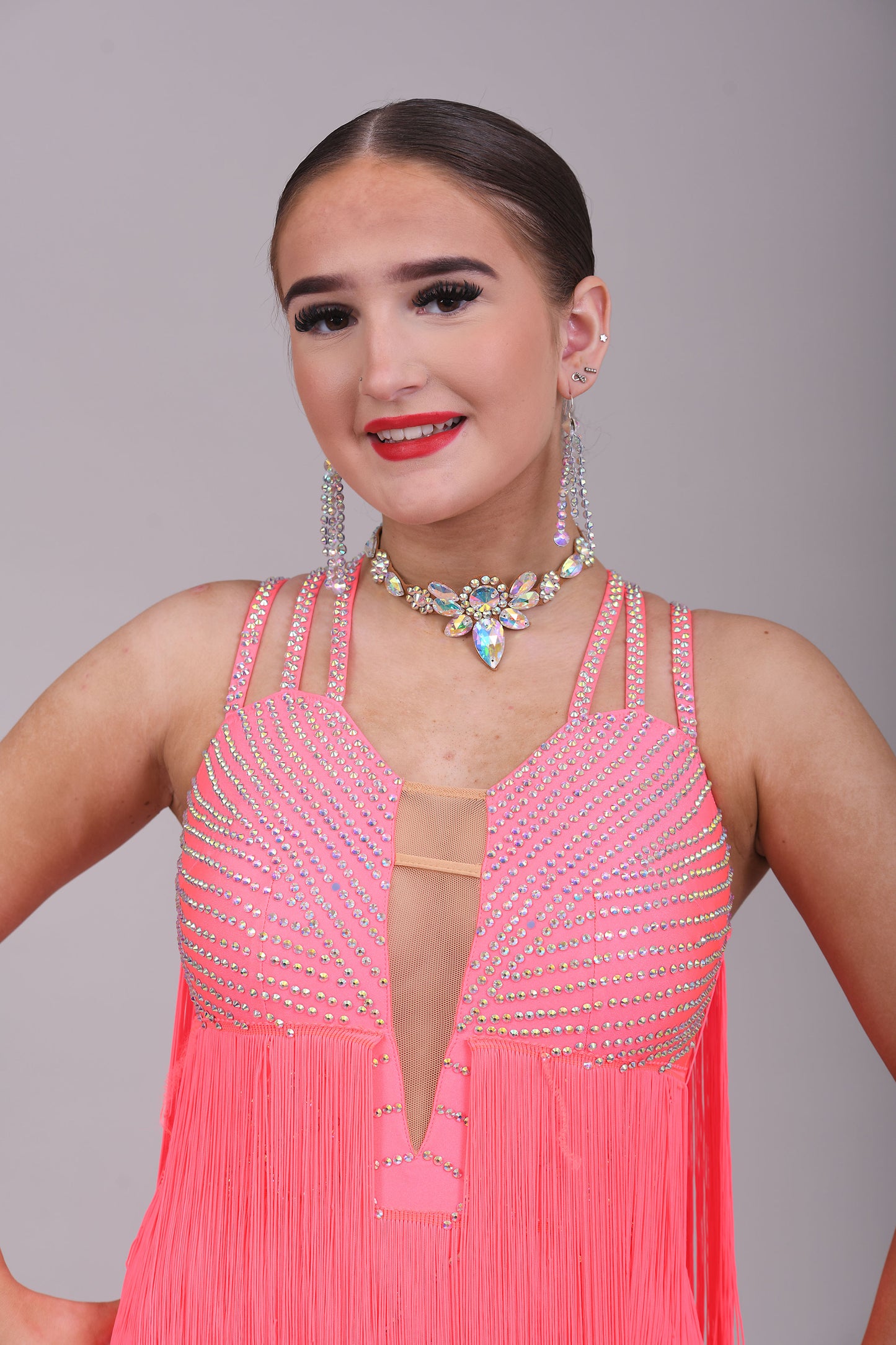 237 Bright Coral Fringed Dress. Decorated in AB stones with strapping detail to the shoulders & back. Matching Skirt, Floats & Belt available on request £135 extra
