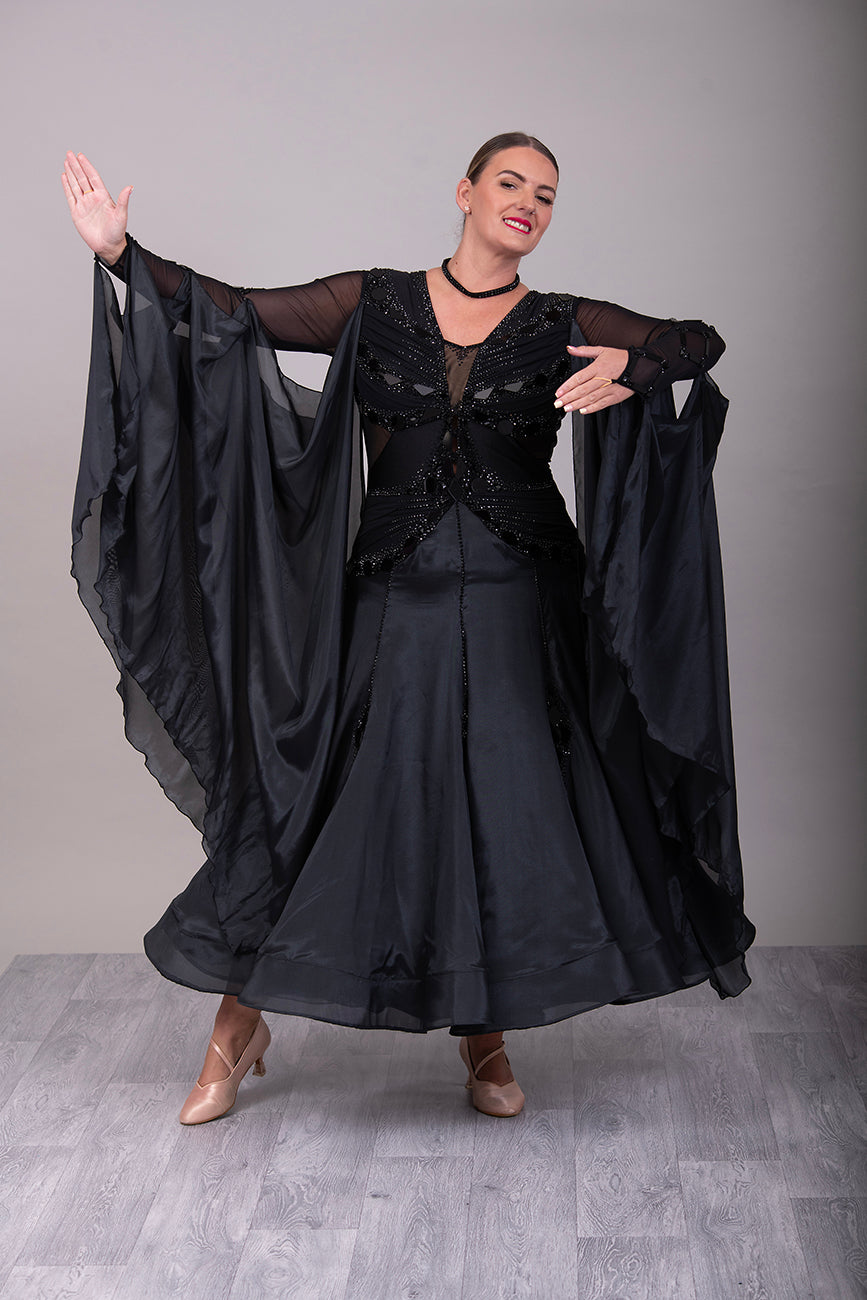 16B Black Ballroom/Sequence Competition Dance Dress. Heavily decorated in Black with Black Mirrors. Decoration continuing down into the Godet Points. A Stand Out & Sophisticated Dress