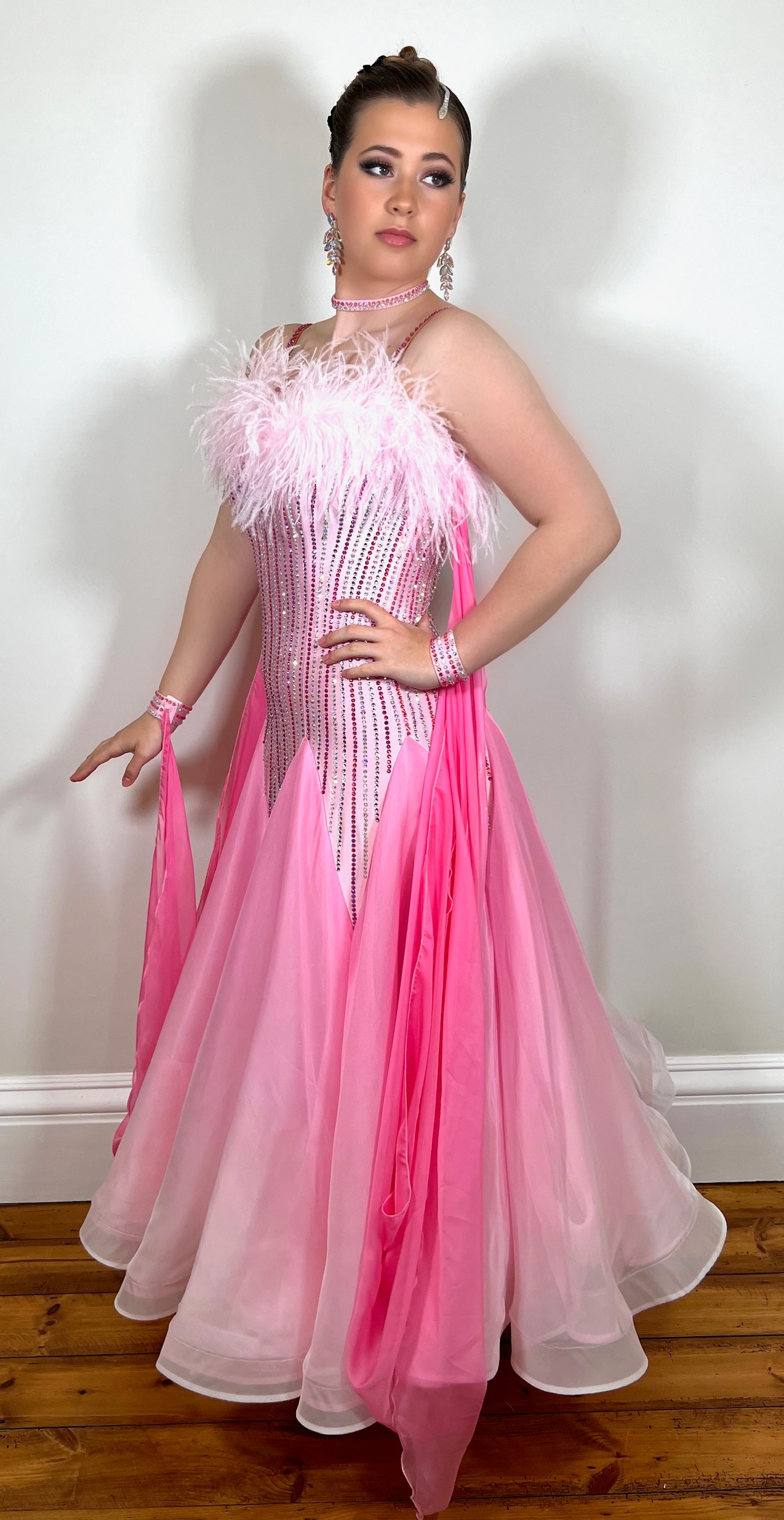 016 Pink & White Ombre Ballroom Dress with Ostrich feather to the upper chest area. Stoned in Light Tose, Rose, Rose AB & AB. Detachable floats