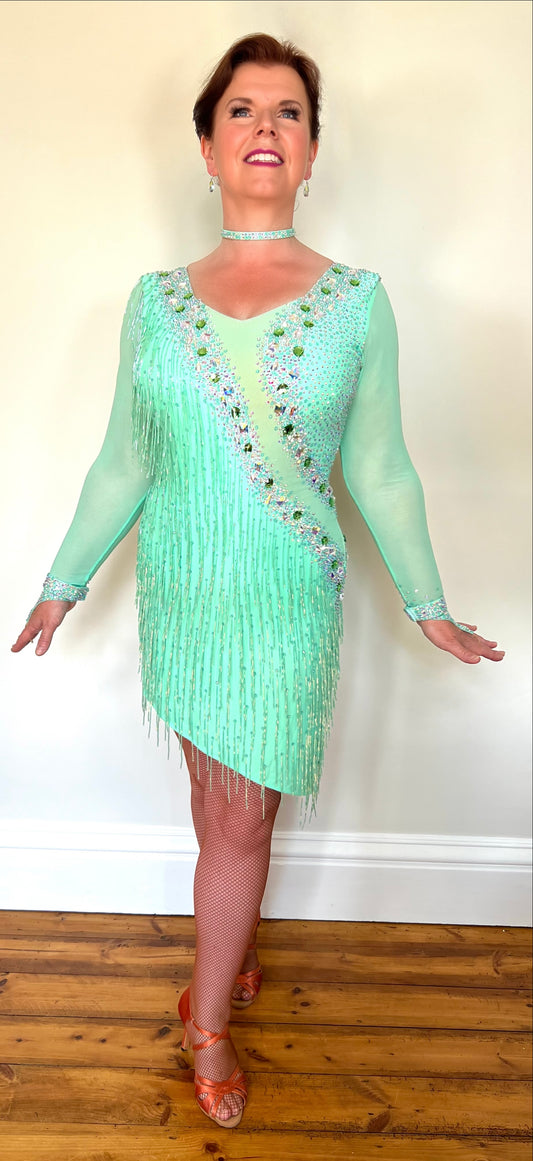 192 Mint Green Latin Dance Dress. Front mesh panel detail with flesh Lycra under so not see through. Stoned in AB and mint ab stones. Mint Green bead droppers. High back giving option to wear own bra.