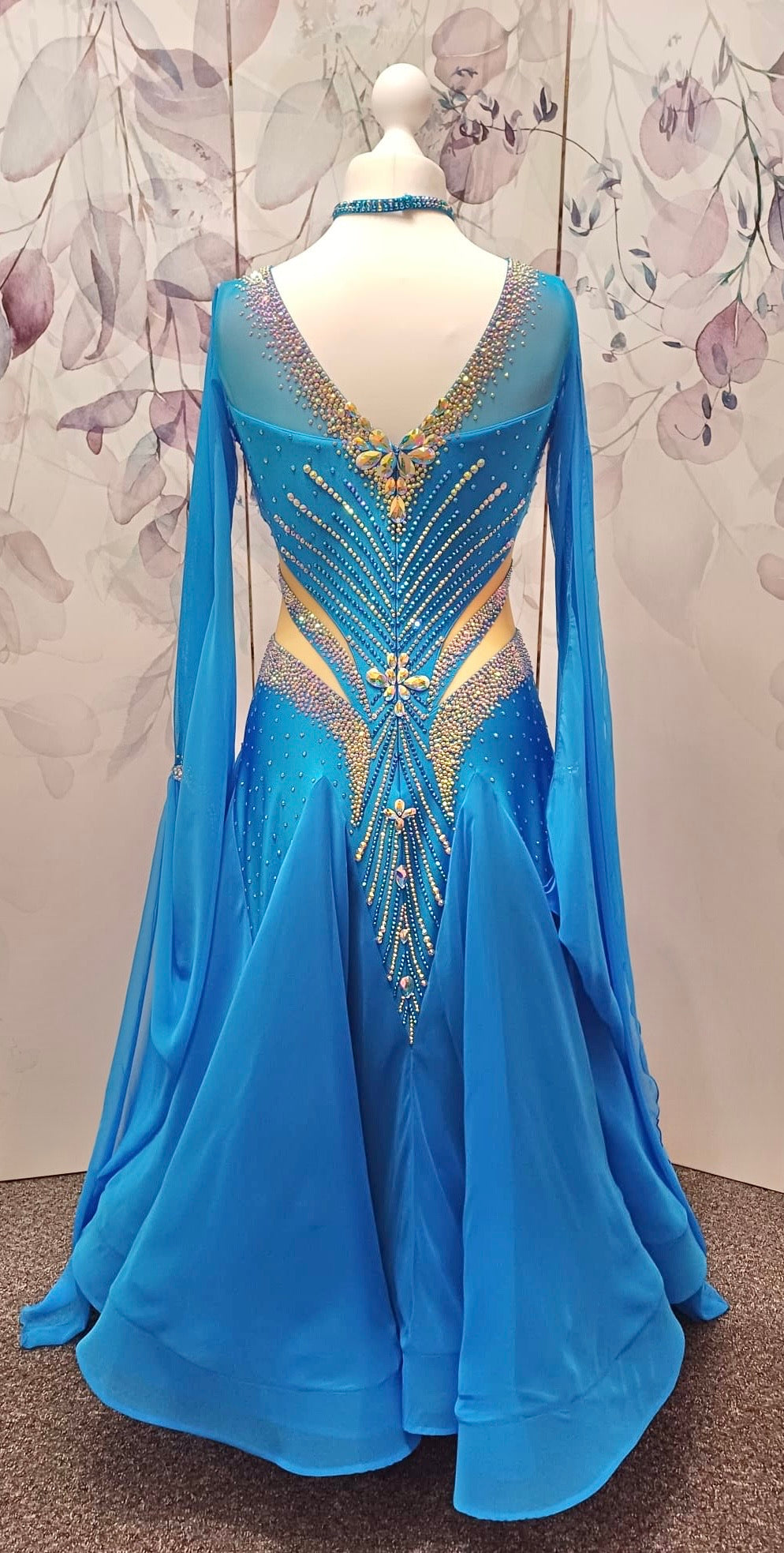 094 Turquoise Competition Ballroom Dance Dress heavily decorated heavily decorated with AB & Capri Blue Stones. Flattering stoned strap detailing detailing to the waist area. High back to give option to wear own bra. Detachable floats