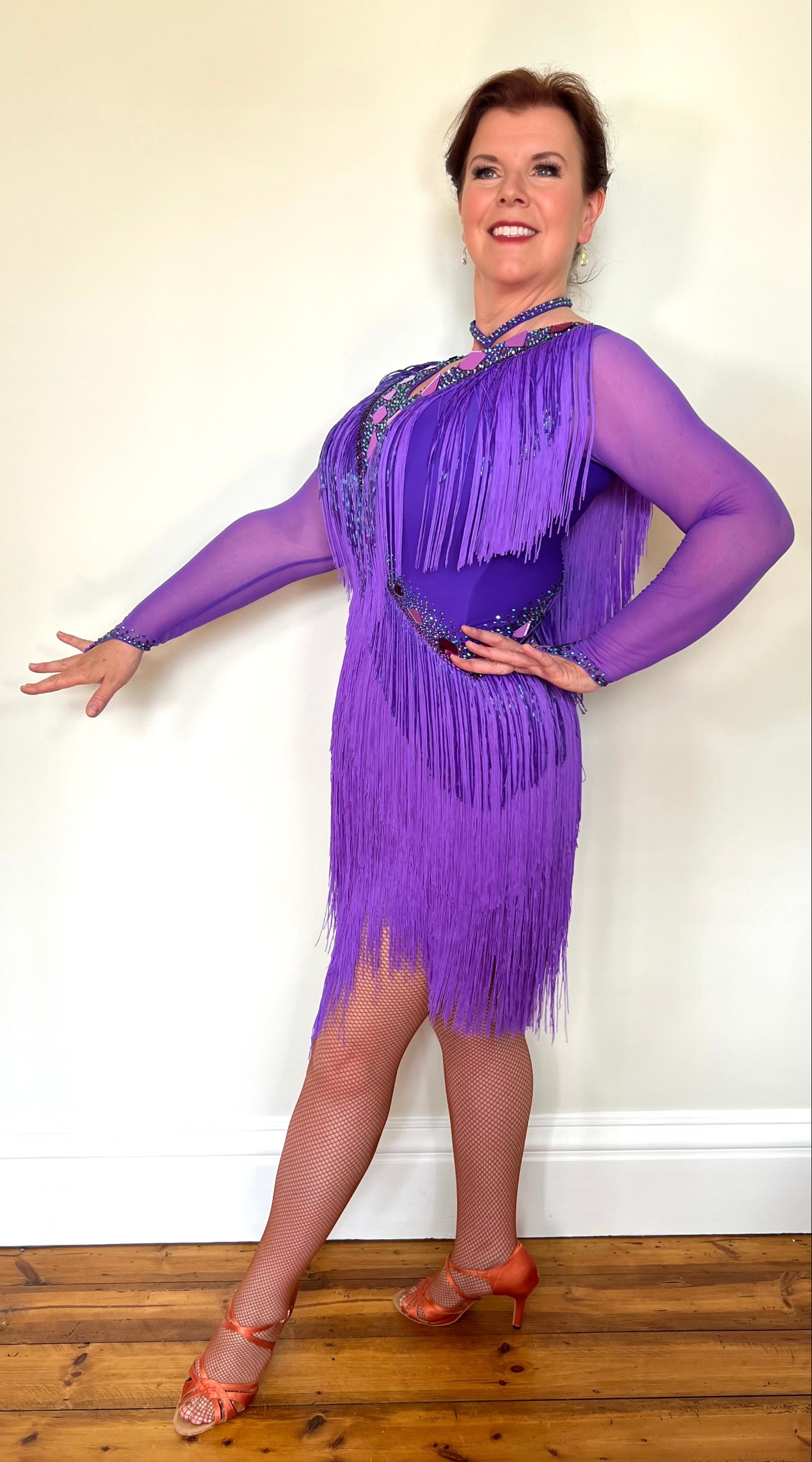 181 Purple Latin Dance Dress. Very full layered fringe. Decorated with purple mirrors, purple bead droppers and purple ab stones. High back to give option for wearing own bra.