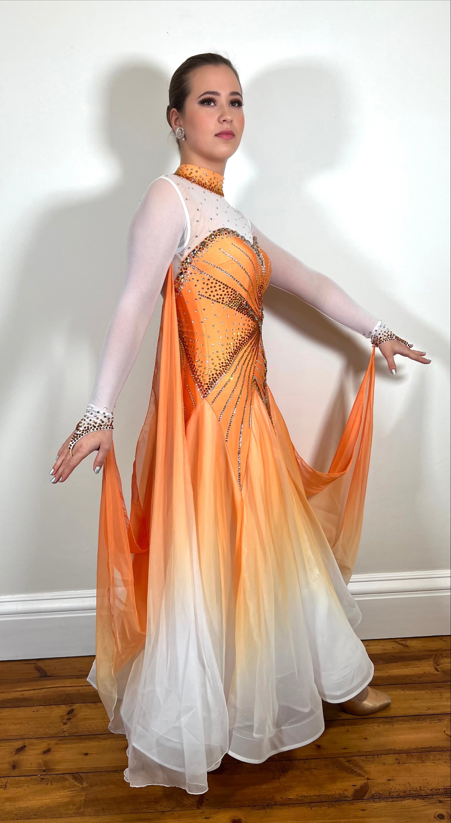 031 Pale Orange & White Ombré Ballroom Dress. Decorated in Smoked Topaz, Light Colorado topaz & crystal. High neck design with keyhole feature to the back. Ombré floats to the sleeves.