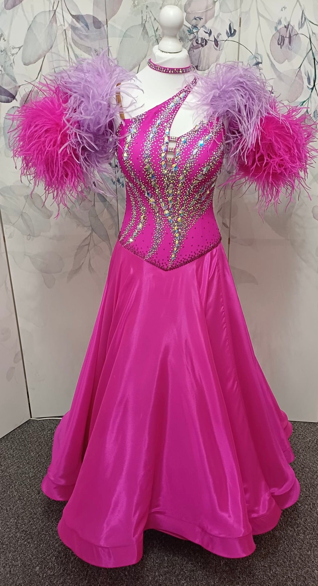 005 Cerise Pink Competition Ballroom Dance Dress. Heavily stoned in AB and Fuchsia & lilac. Comes with ostrich cuffs in Lilac & Cerise. Beautiful back detail.